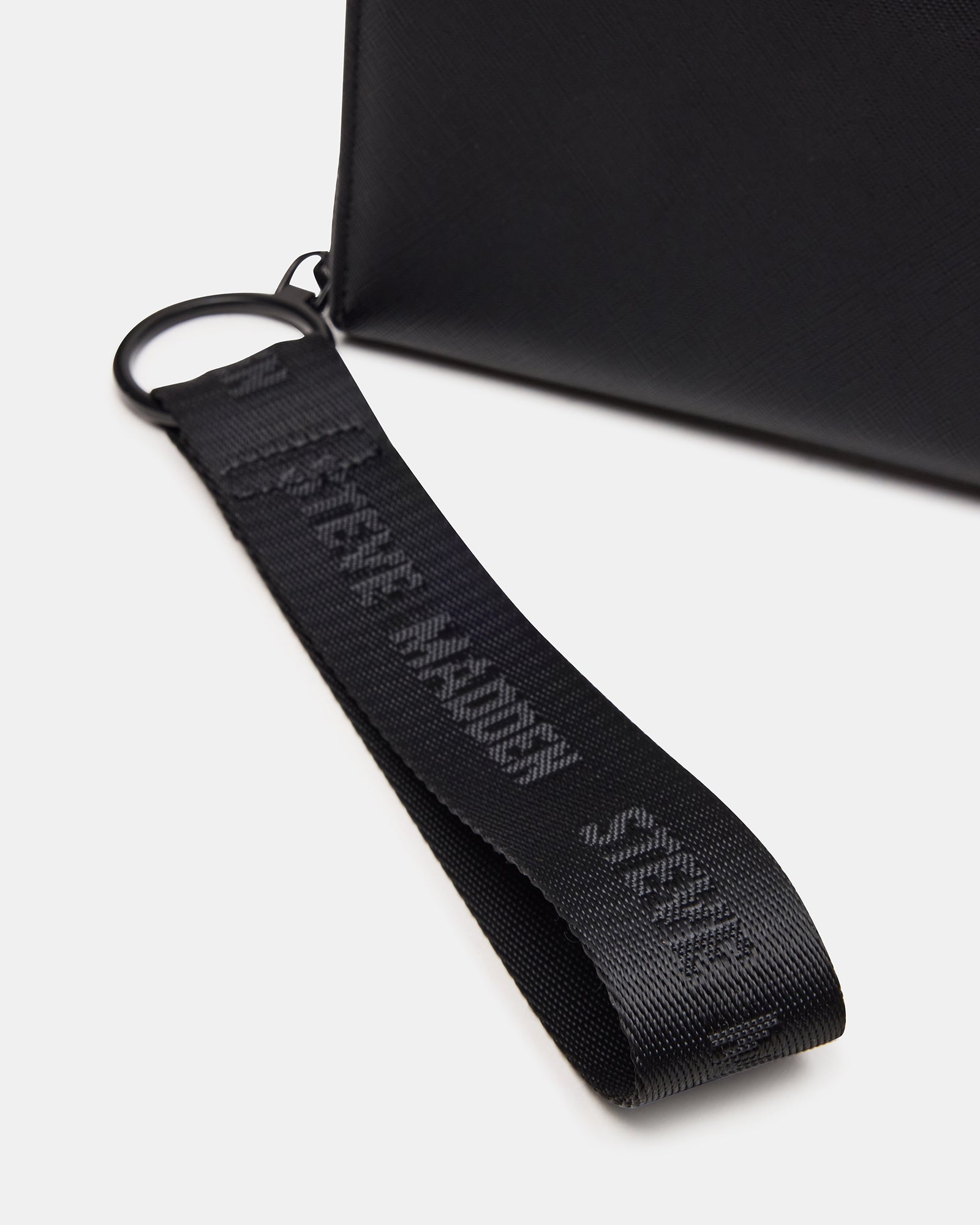 Black wristlet wallet worn on wrist, showcasing portability