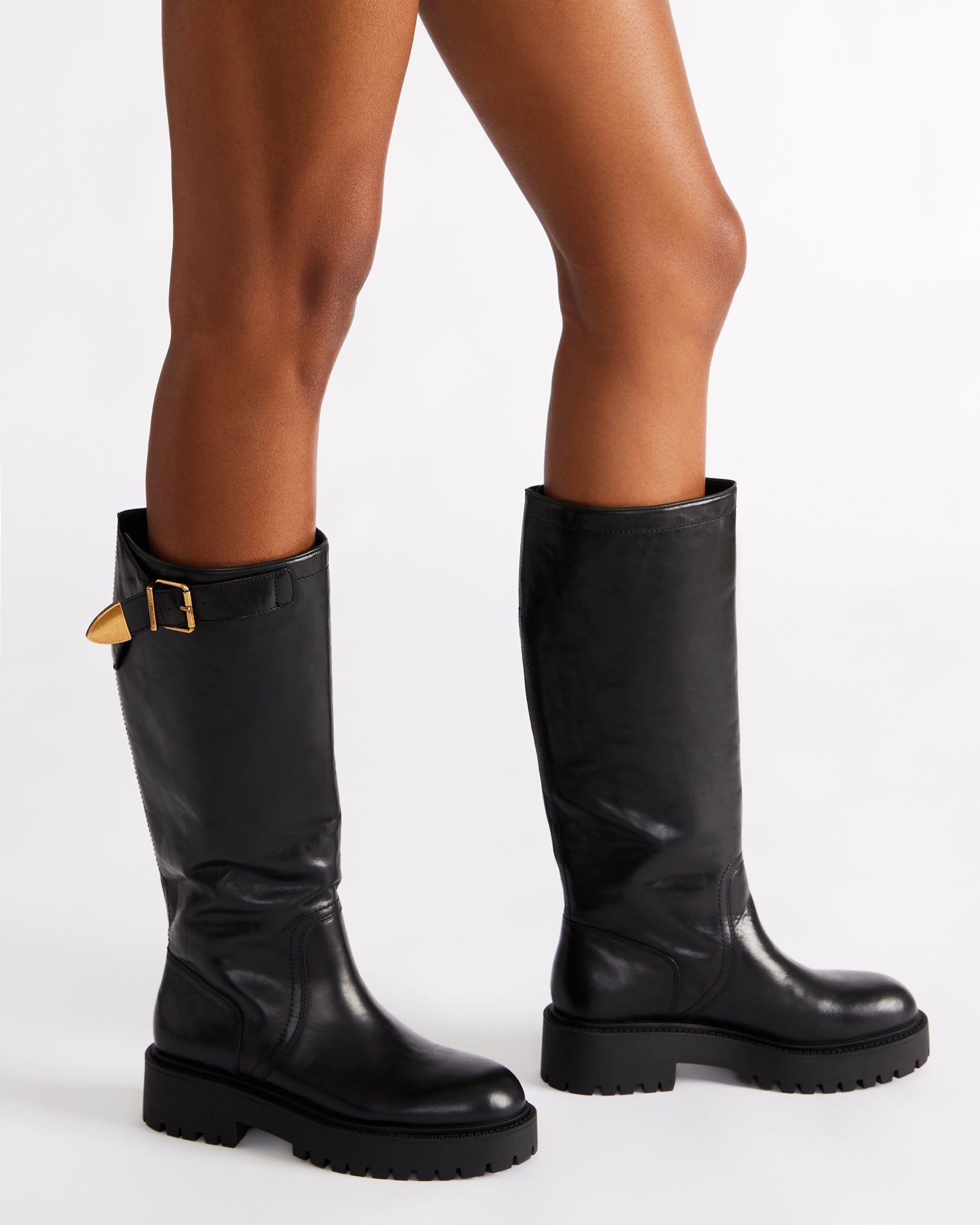 Close-up of leather boots cognac finish and stitching details