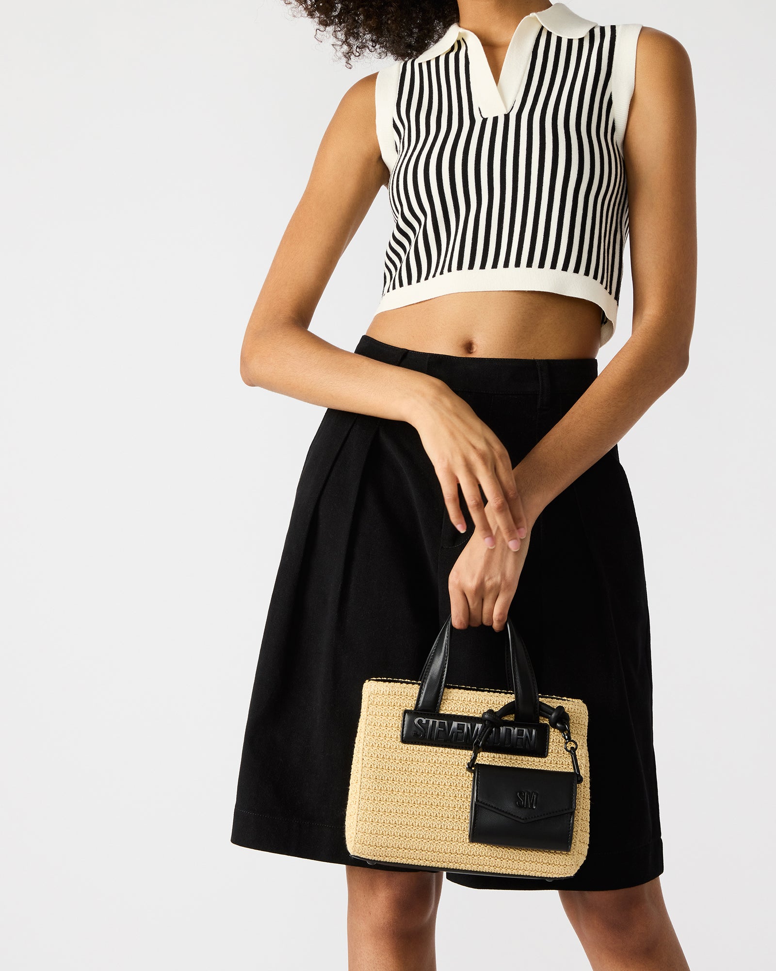 Close-up of the mag snap closure and expandable gusset on the straw tote