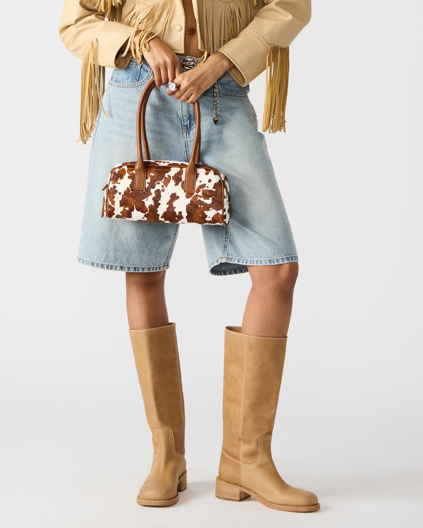 Front view of Anise cow print shoulder bag with exaggerated tubular straps