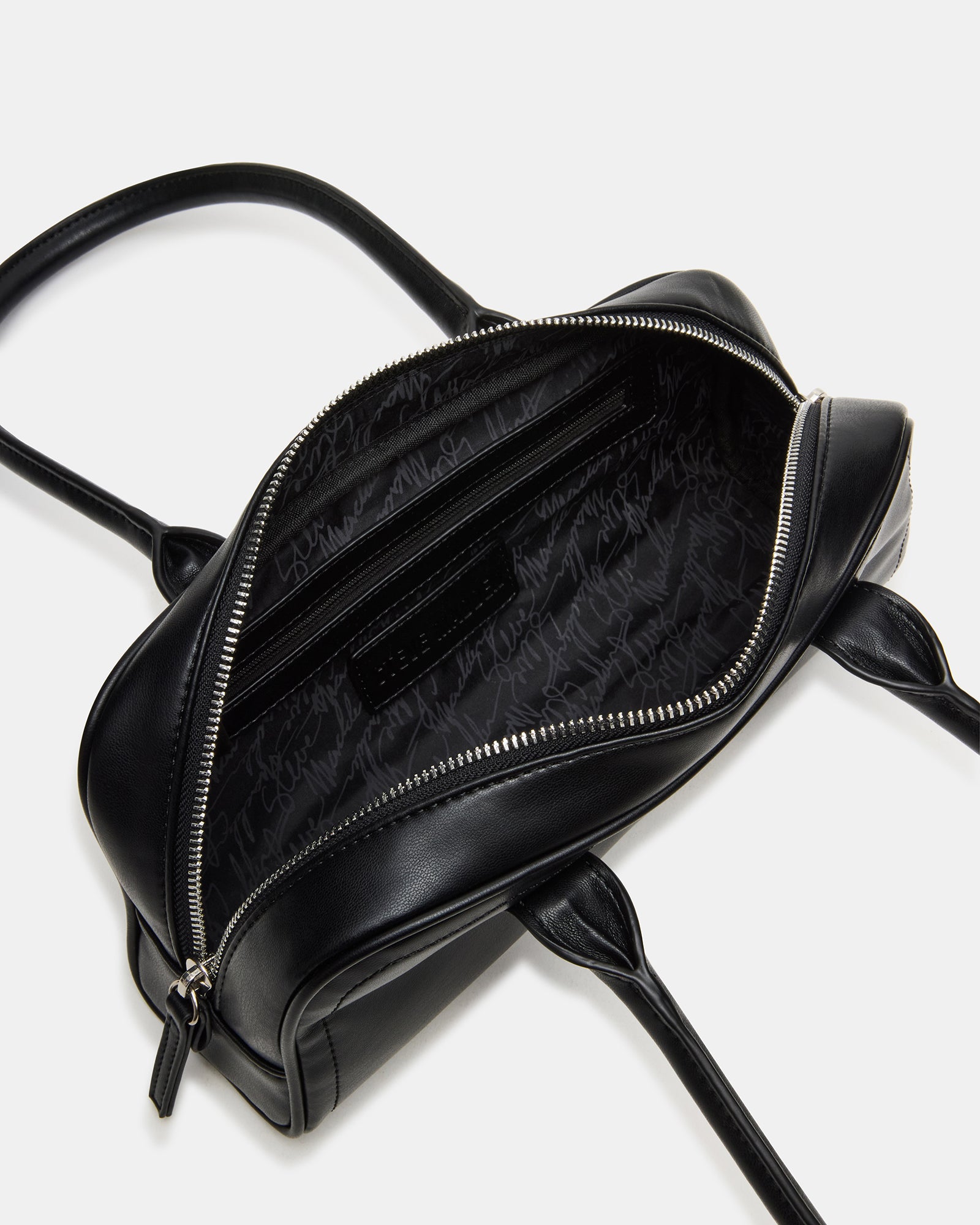 Interior organization of the Coach shoulder bag showing the front pouch.