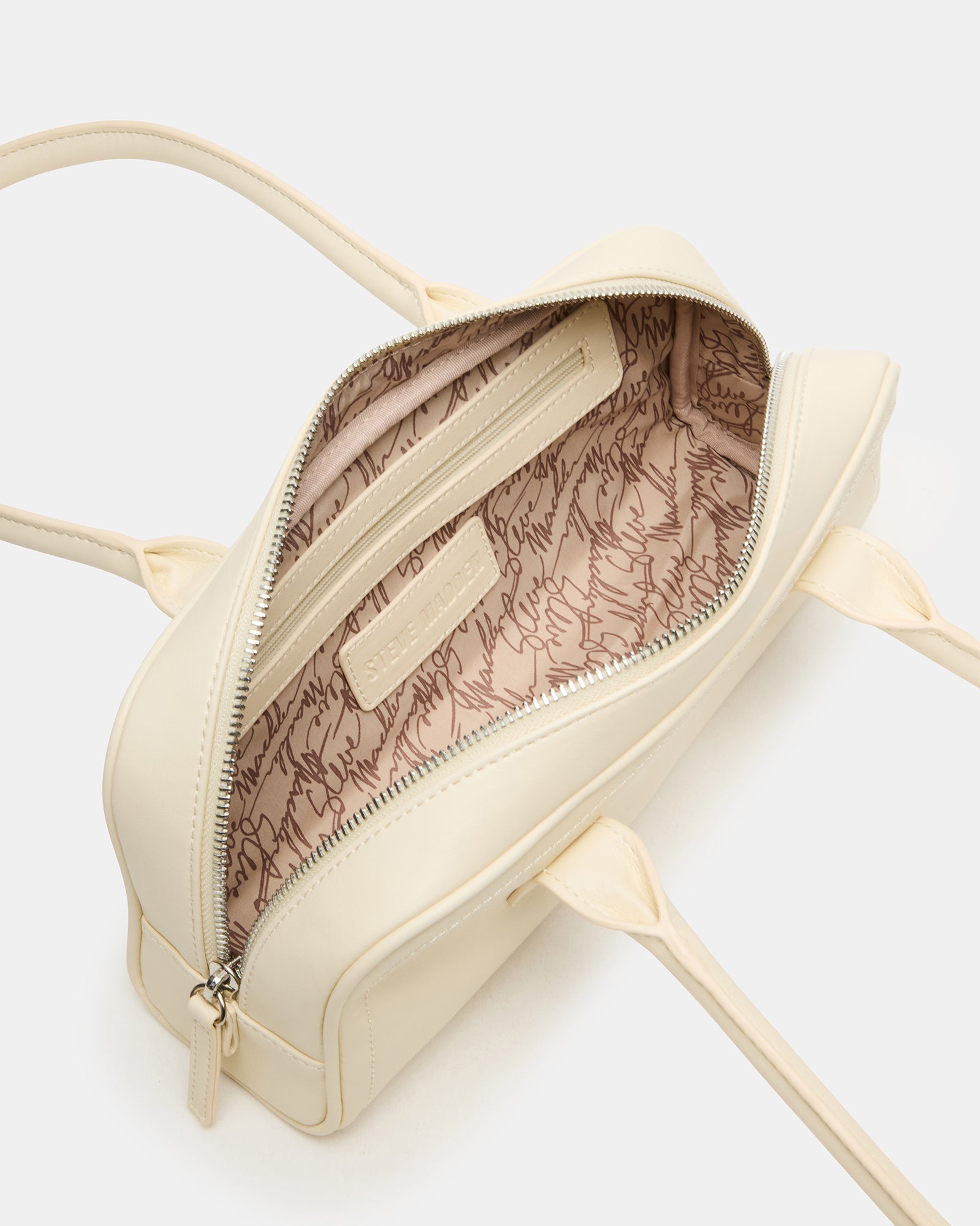 Detail of the exaggerated tubular shoulder straps on the chic shoulder bag, emphasizing style and comfort.