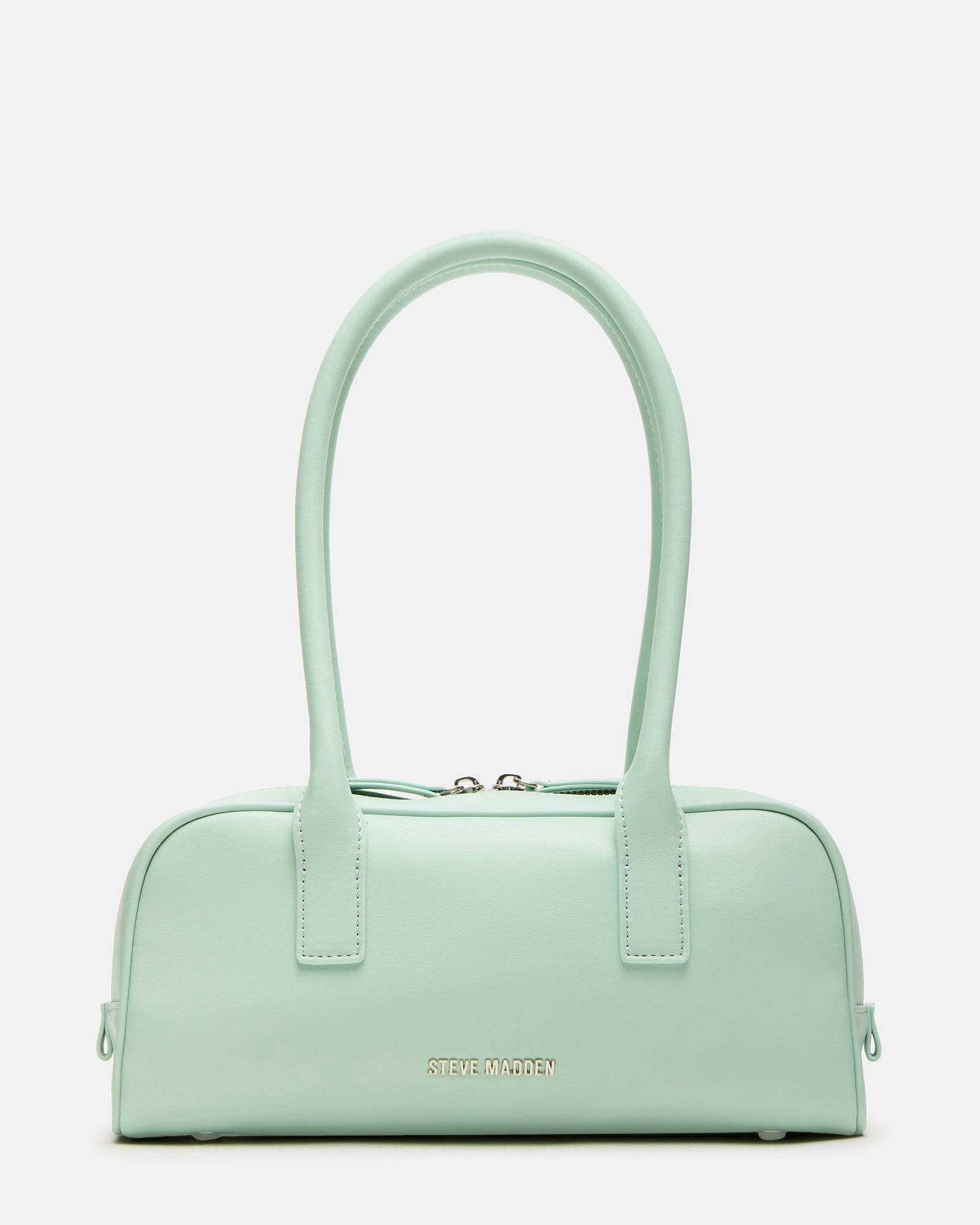 Pistachio shoulder bag styled with casual outfit in a chic urban setting.