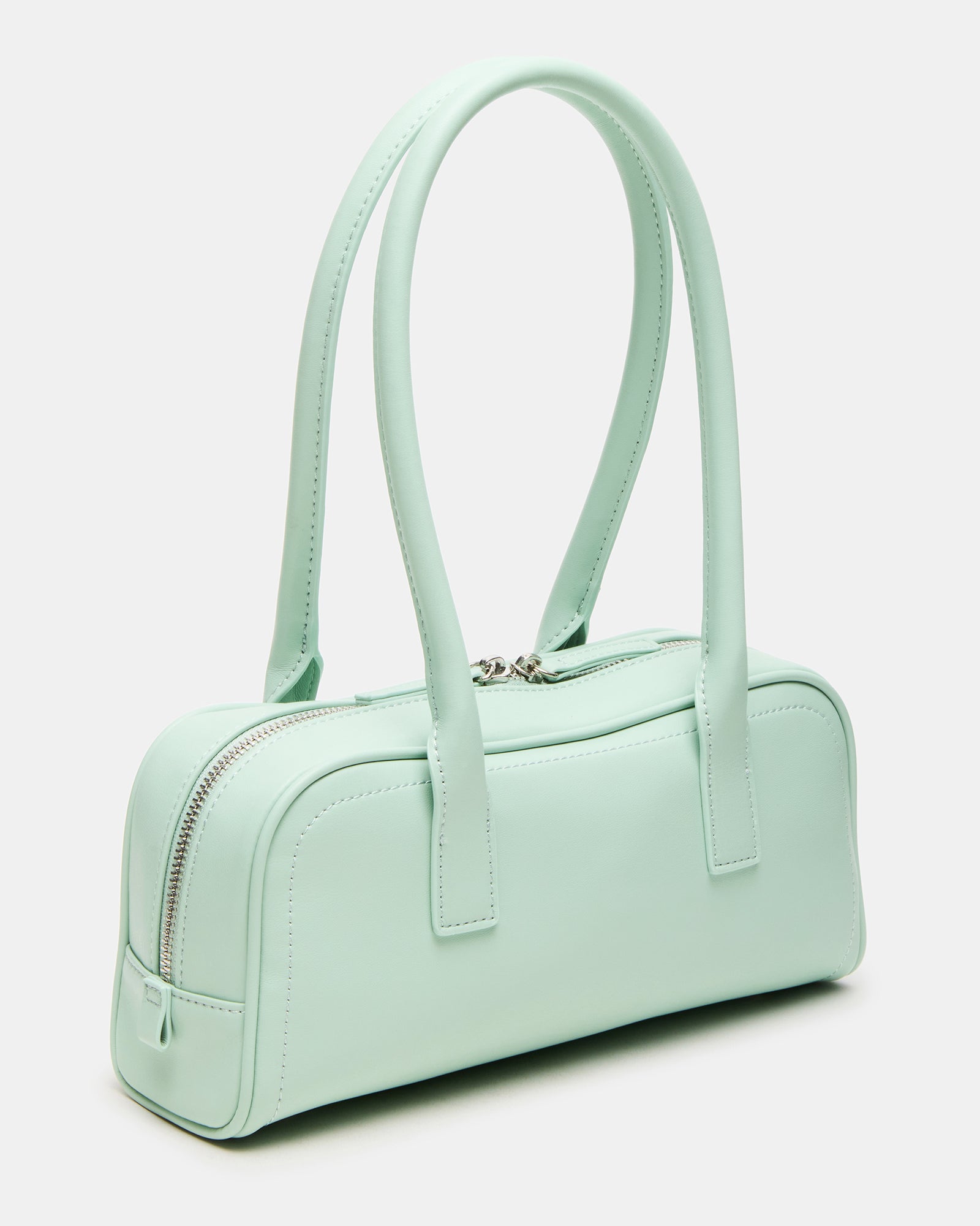 Pistachio minimalist shoulder bag displayed against a stylish backdrop.