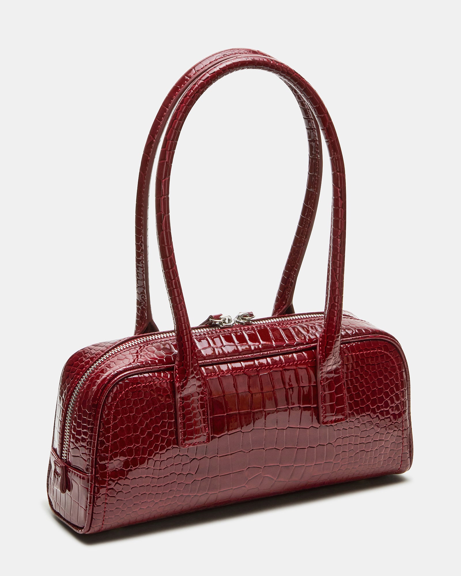 Front view of red croc bag with tubular shoulder straps on a marble surface