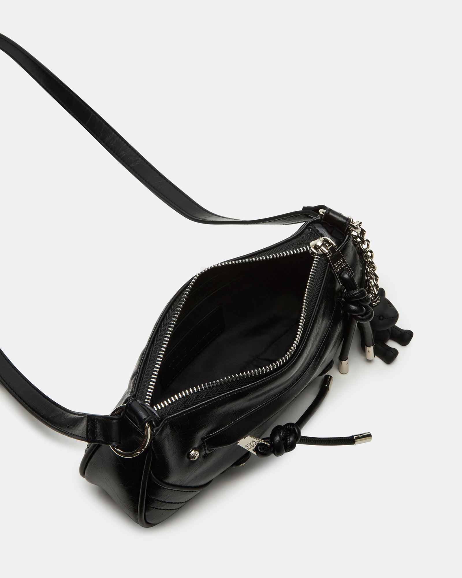 Front view of the black shoulder bag with detachable teddy charm shown on white background