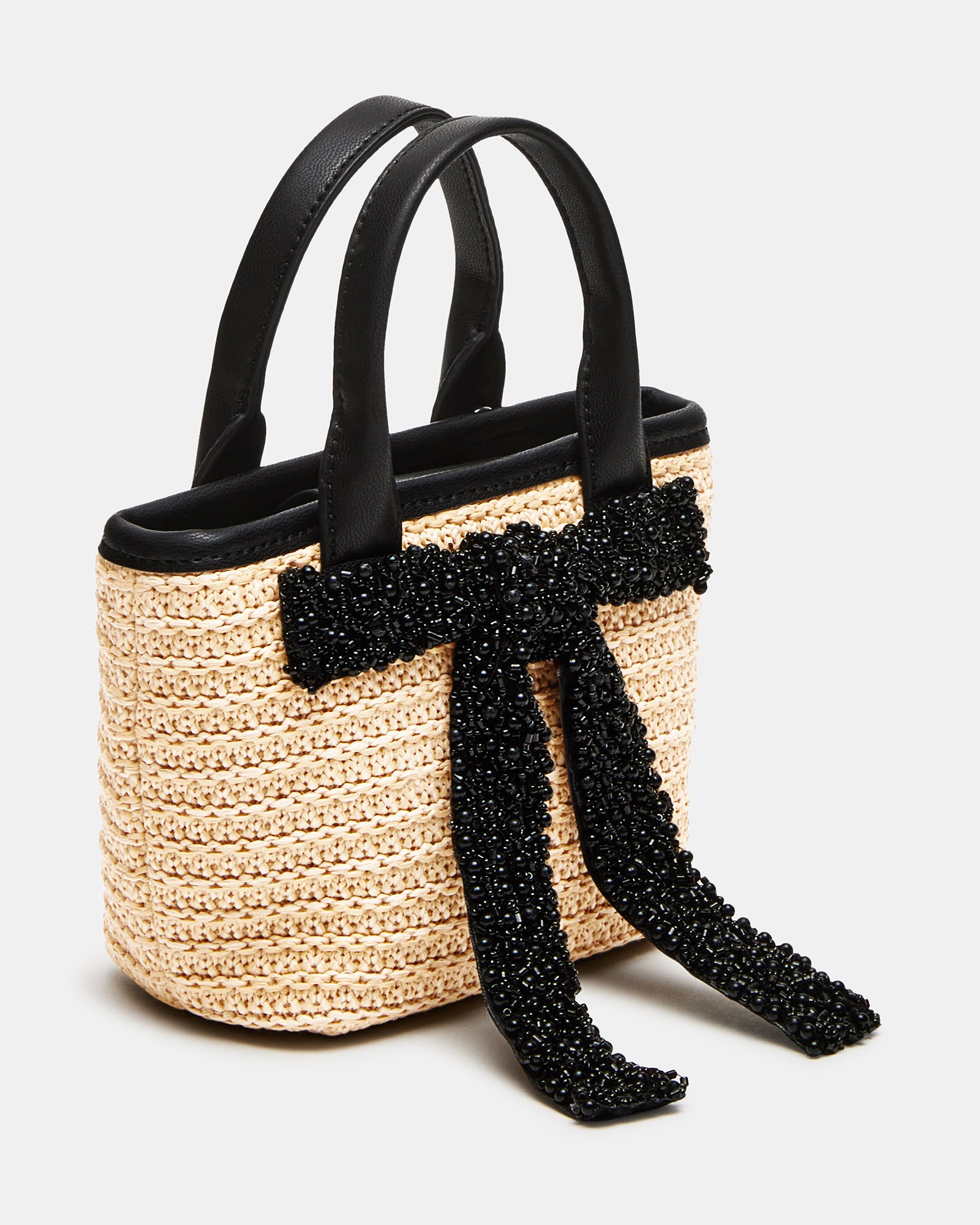 Front angle showing the beaded bow and top-handle strap against NYC street style backdrop