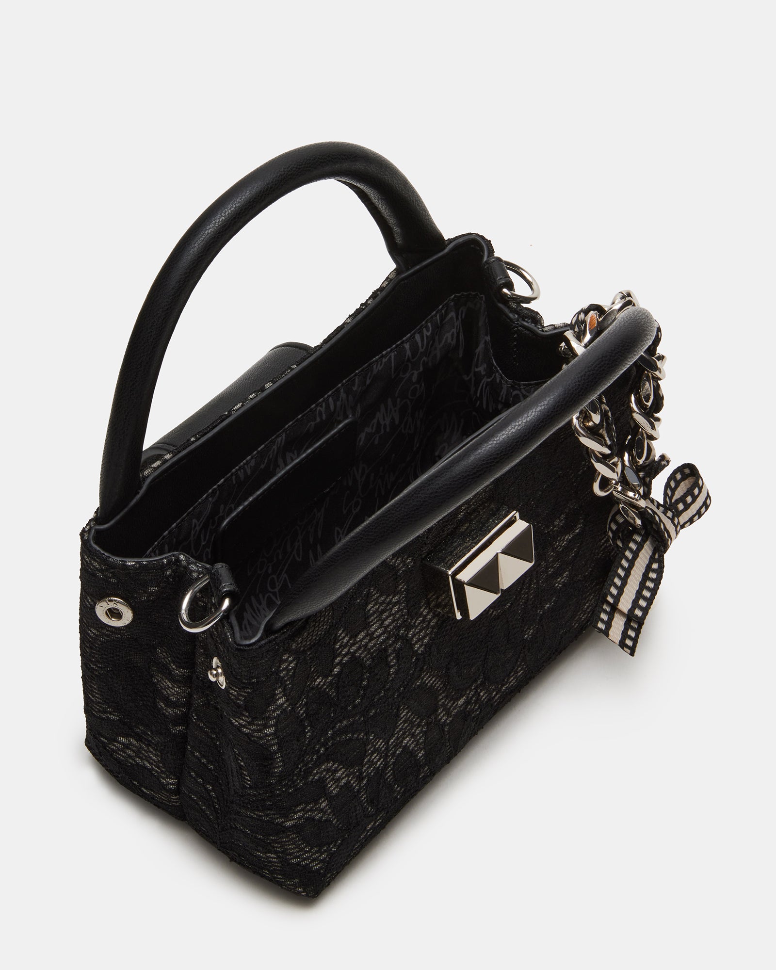 Close-up of the chic bow and turn lock on the black lace crossbody bag.