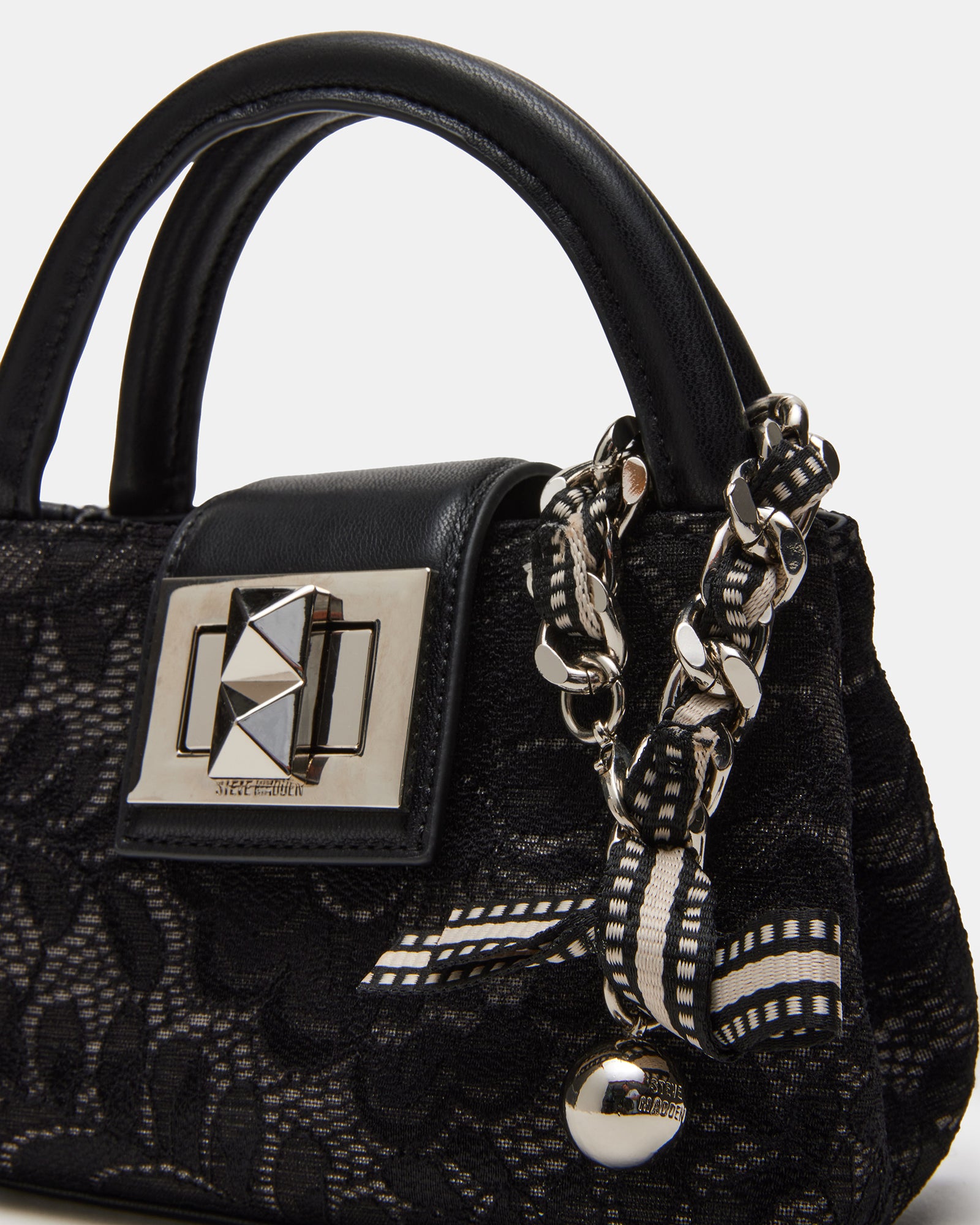 Model wearing a black lace crossbody bag, showcasing its hands-free convenience.
