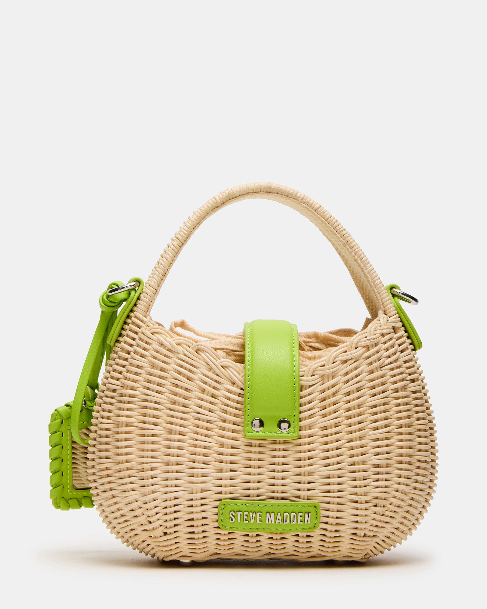 Styled shot of the Canela Lime bag worn crossbody for a casual daytime look