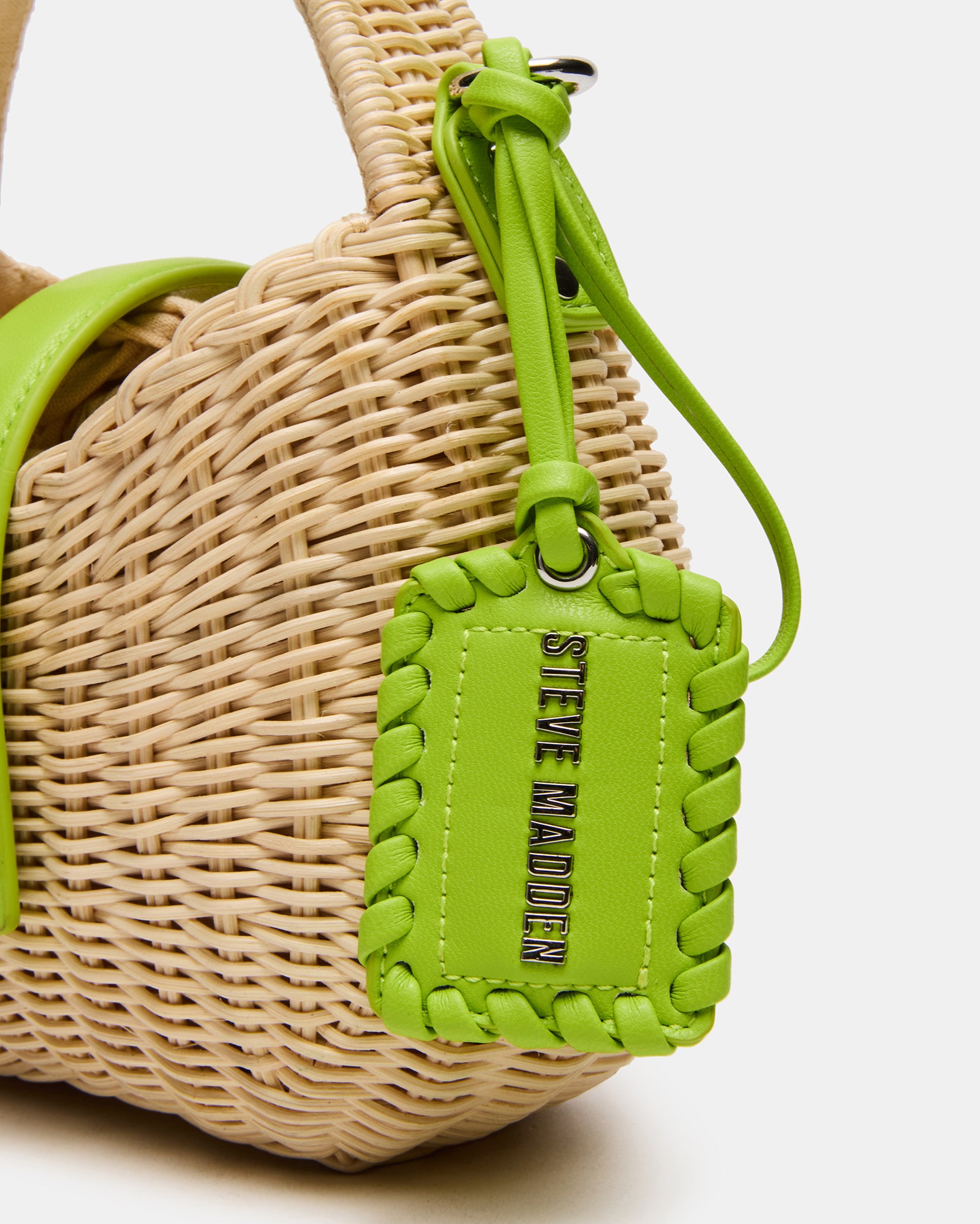 Styled shot of the Canela Lime bag worn crossbody for a casual daytime look