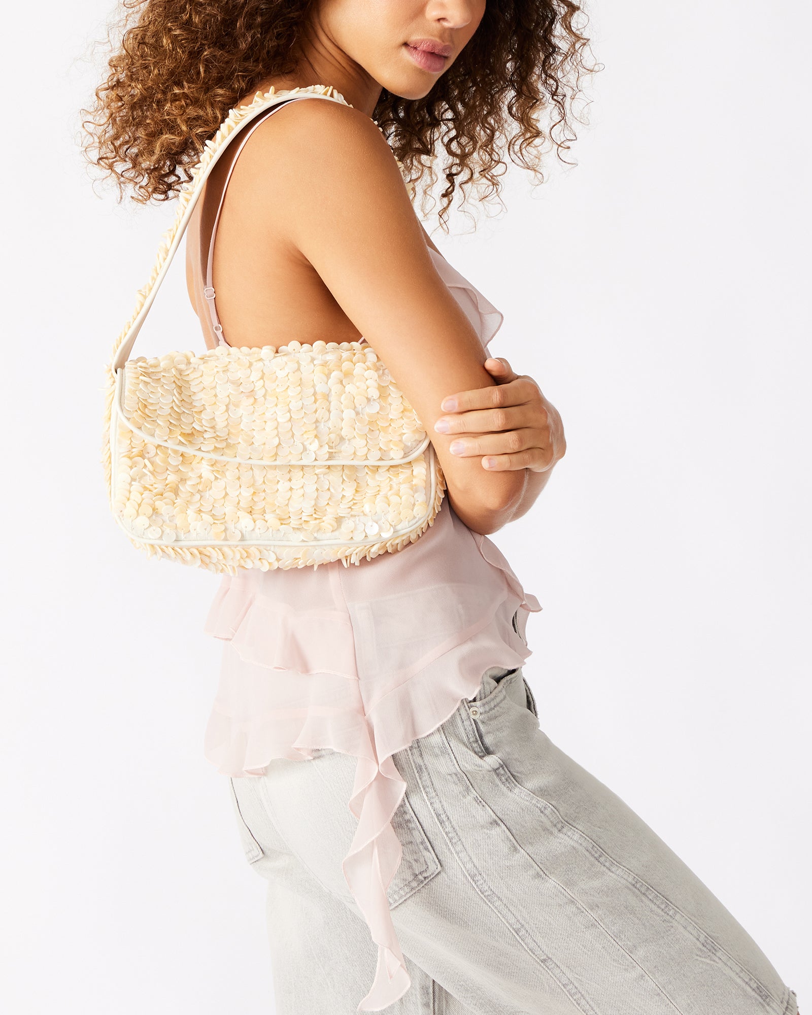 The Charli bag with its front flap and mag snap closure, styled for a night out