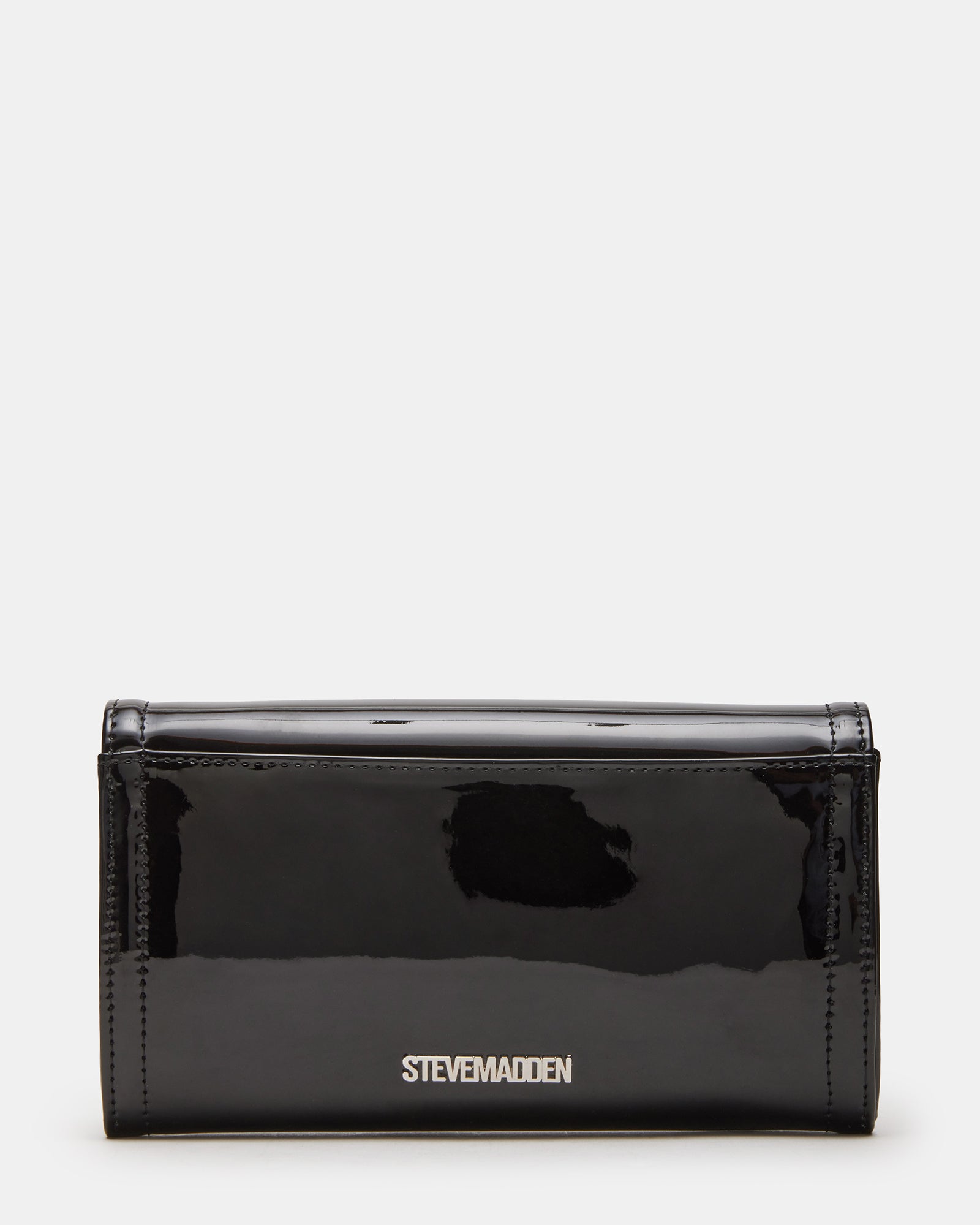 Styled image of the black patent clutch bag paired with elegant evening attire