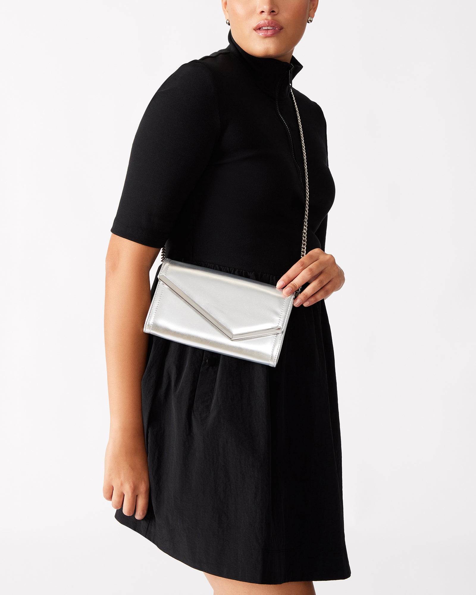 Side view highlighting the removable chain strap of the crossbody clutch bag.