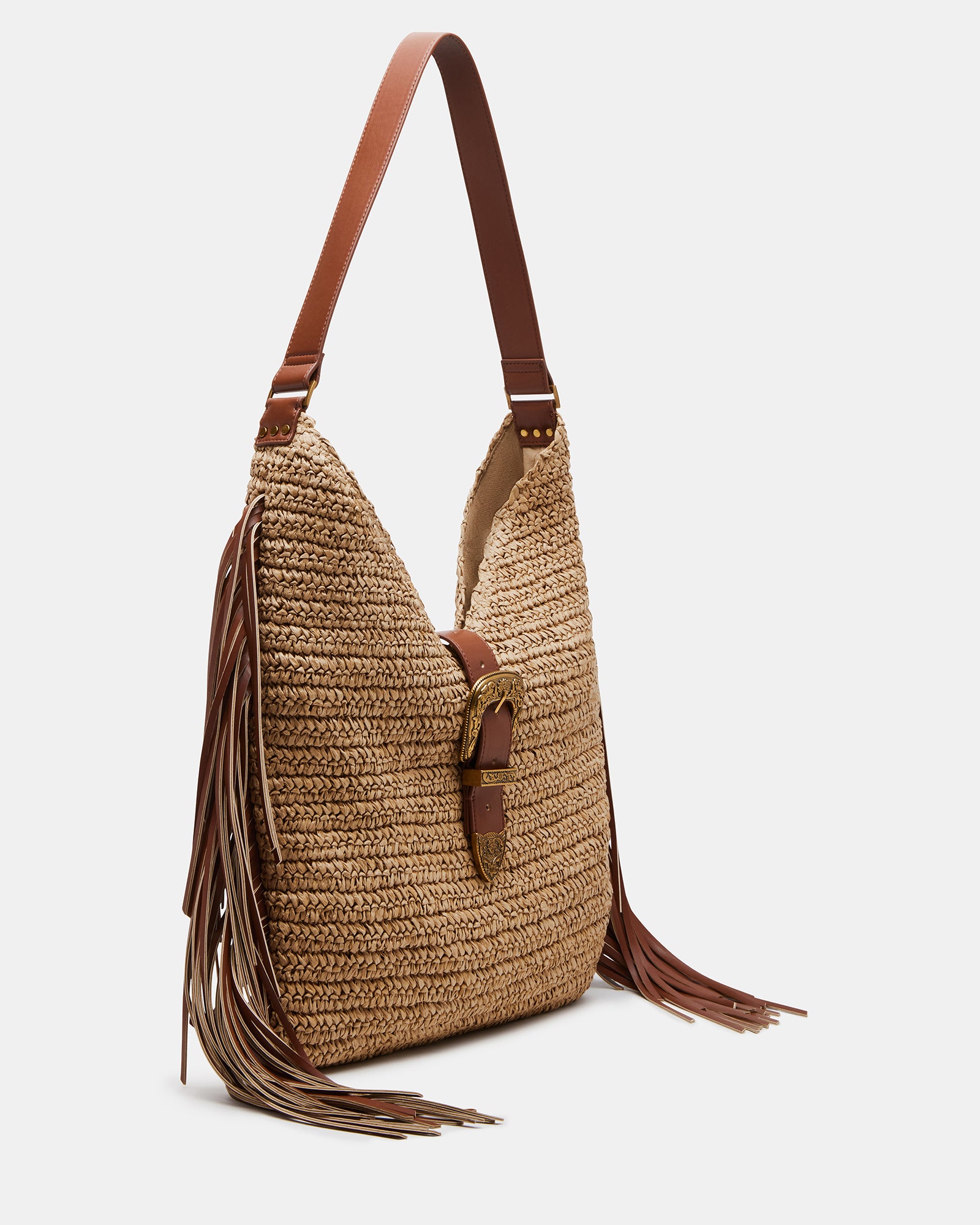 Coltie fringe tote bag displayed in a park setting, showcasing its design.