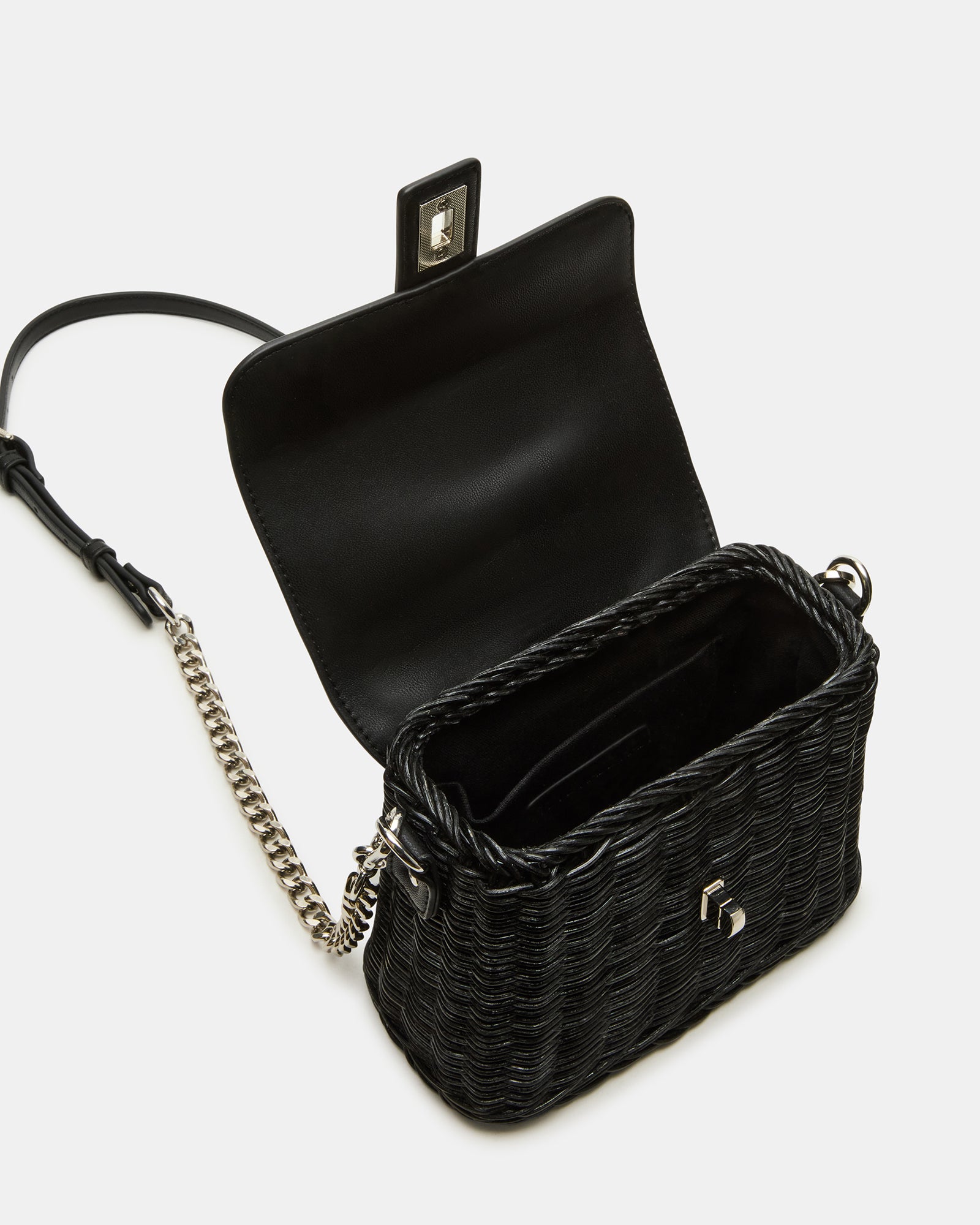 Close-up of wicker texture and turn-lock closure on the black handbag