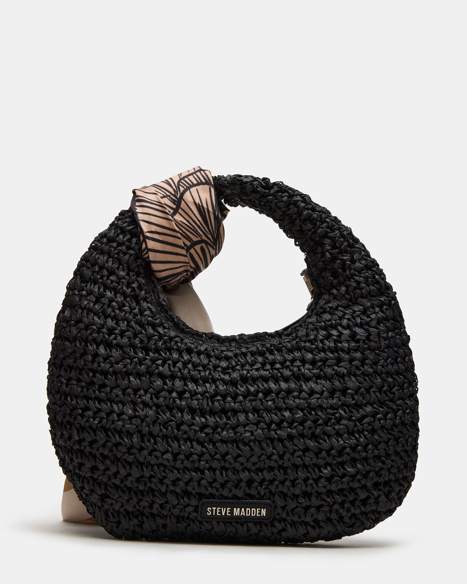 Model carrying the coach teri shoulder bag straw for a trendy look