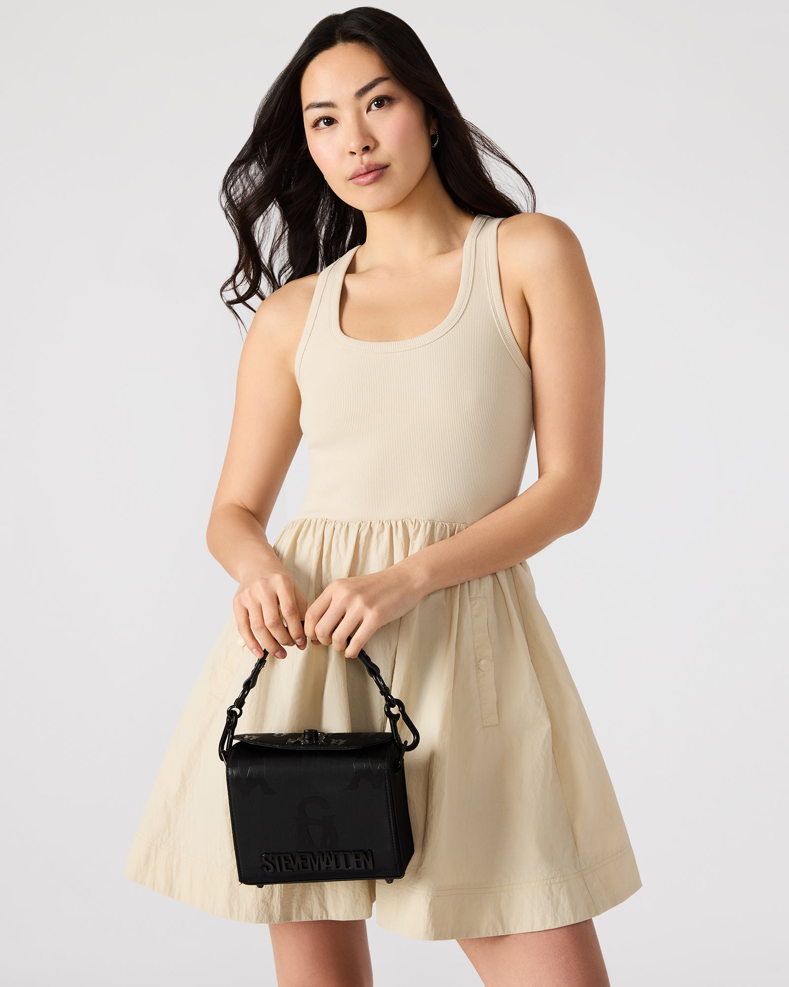 Model wearing the structured handbag crossbody-style while walking in SoHo.
