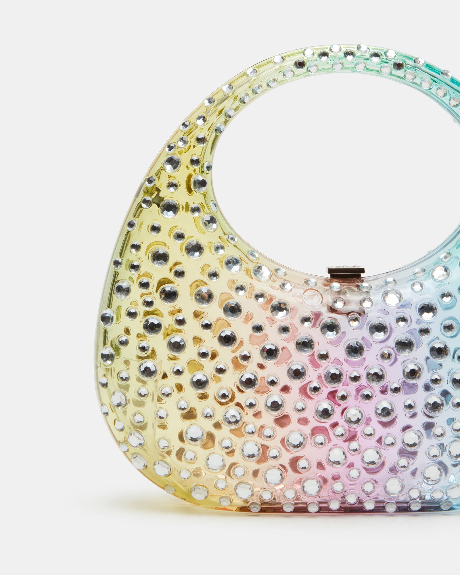 Model wearing clear shoulder bag with rhinestones crossbody in urban setting