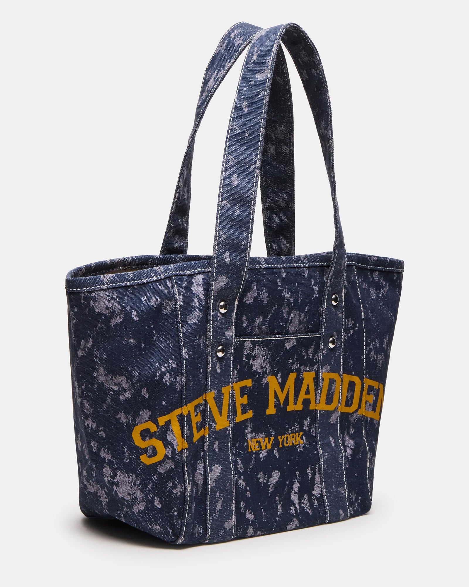 Close-up of stud rivet and stitching detail on denim tote bag