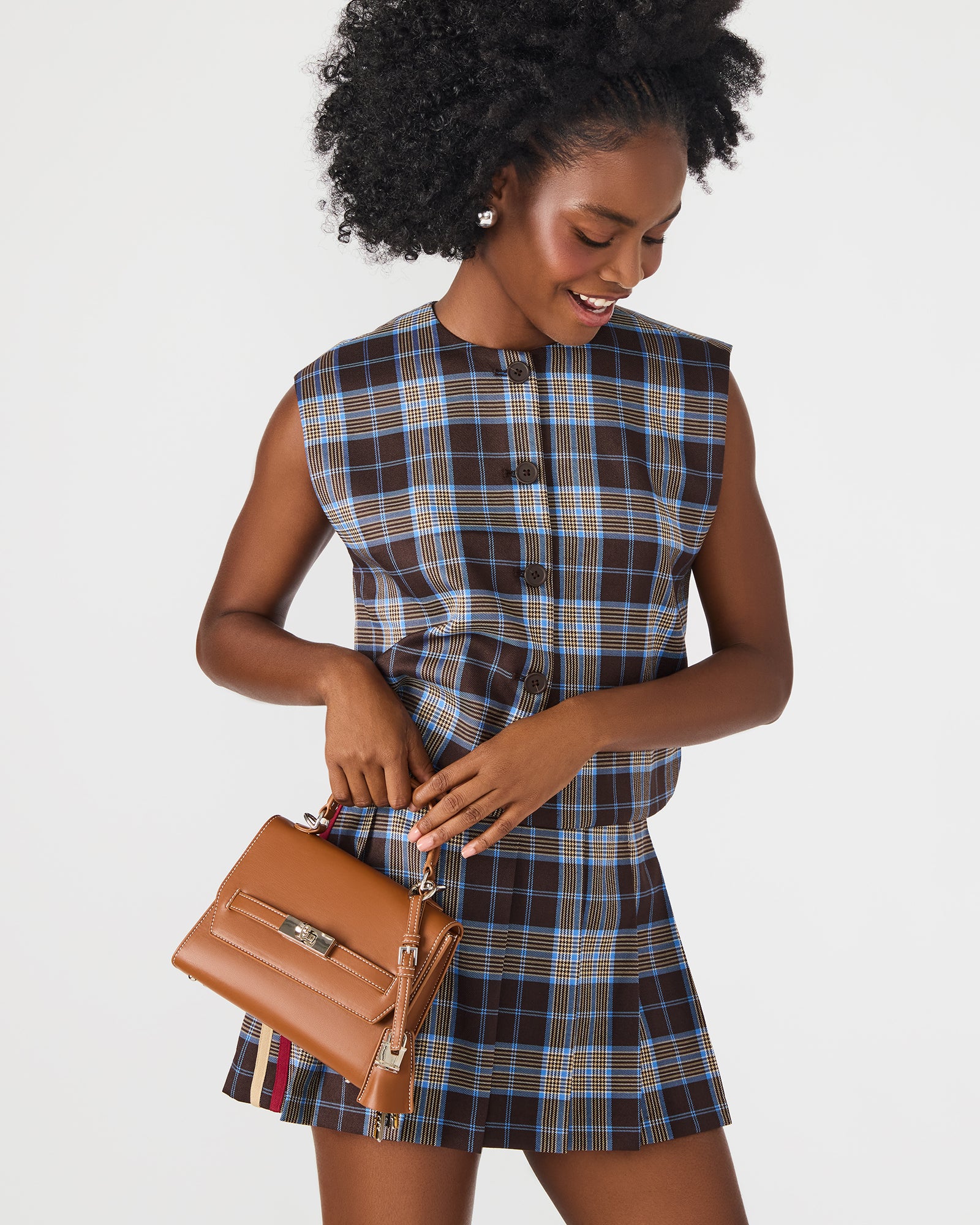 Side profile of structured bag with adjustable strap visible