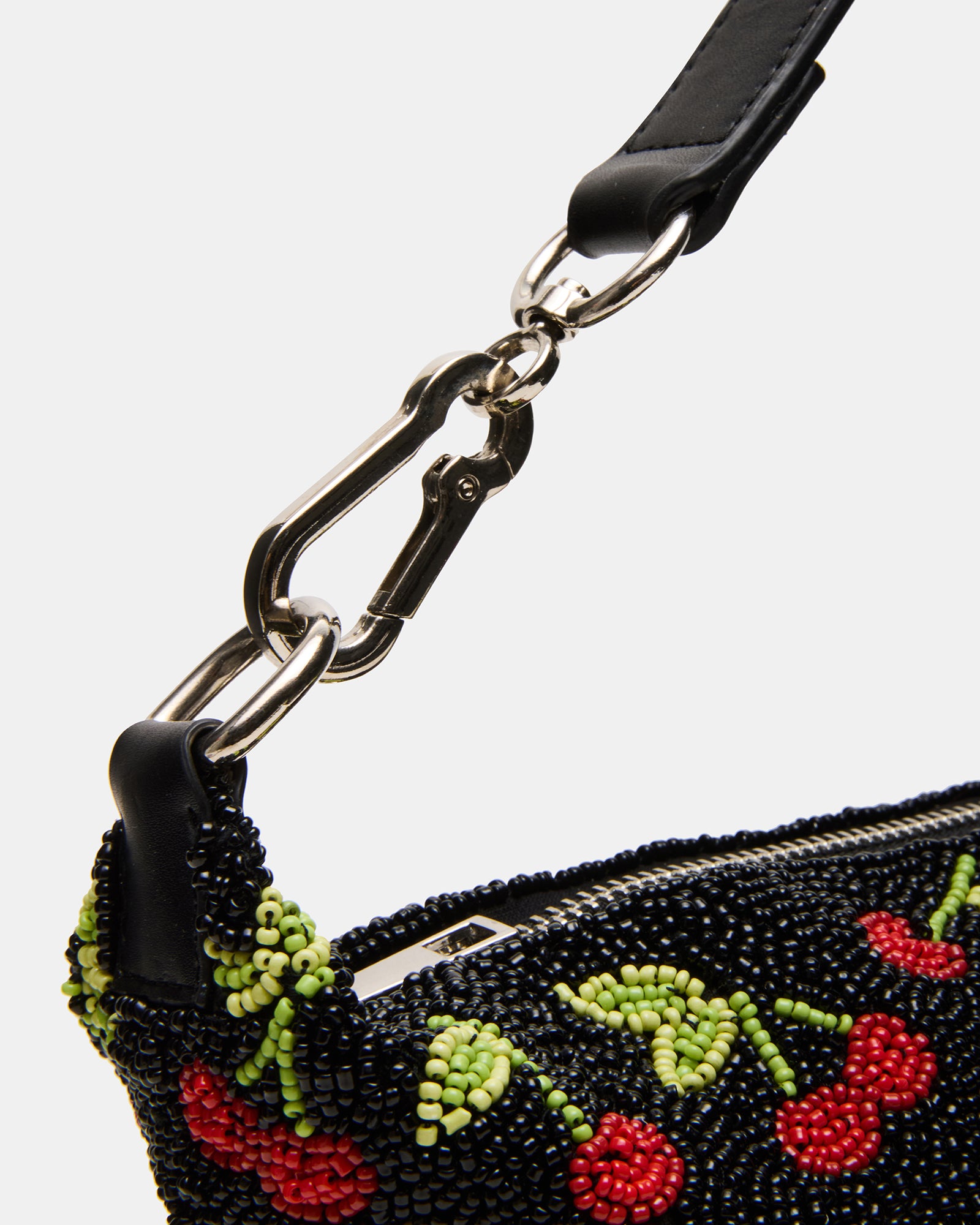 Close-up of the beaded details and zipper closure of the shoulder bag.