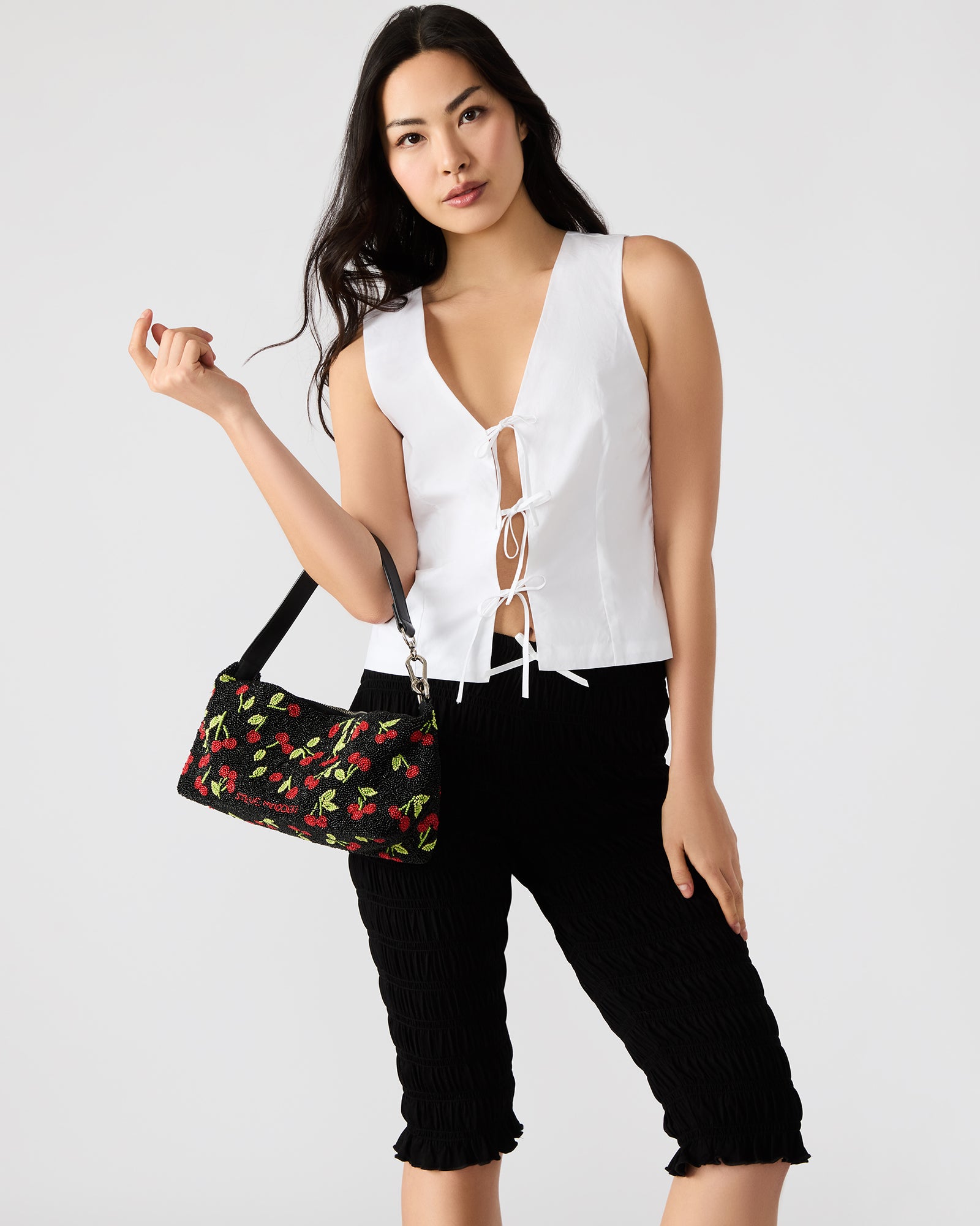 Side angle of the black multi beaded bag highlighting the shoulder strap.