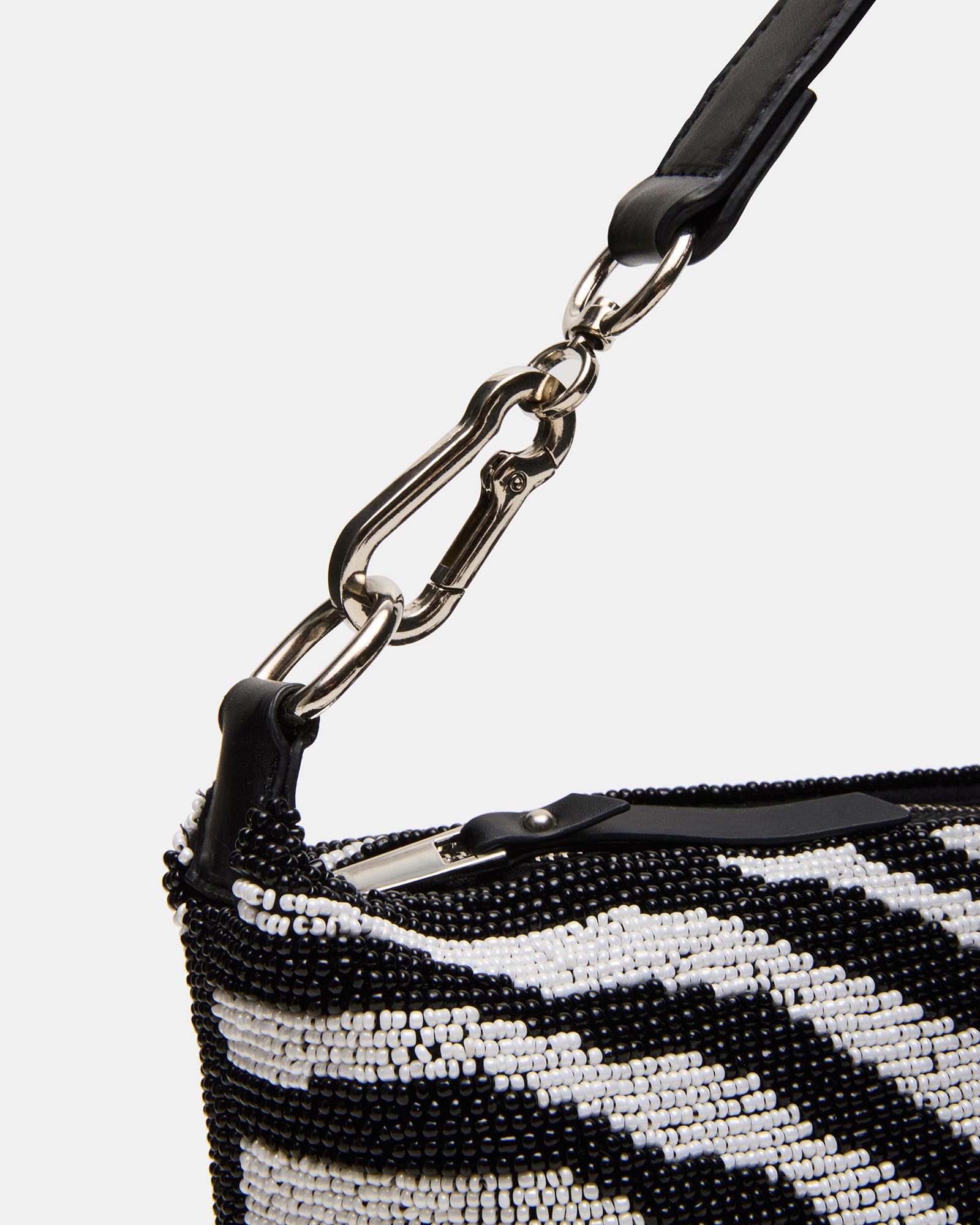 Model carrying the beaded handbag with urban backdrop