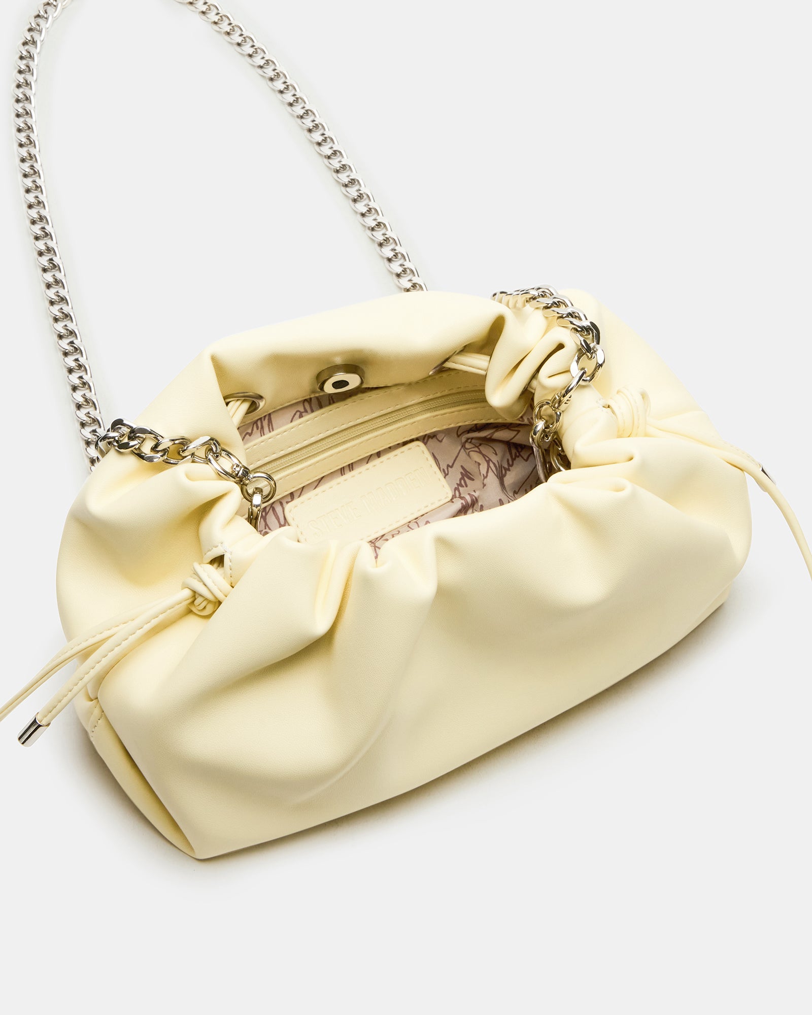 Side angle highlighting the scrunched pouch design and removable chain
