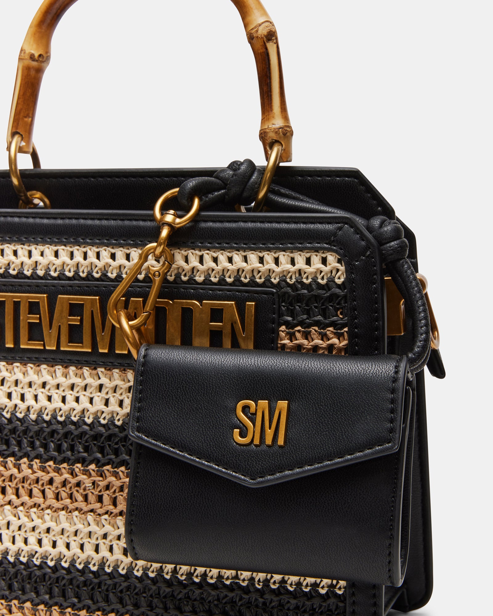 Close-up of the top handle of the Evelyn designer straw bag, highlighting its craftsmanship.
