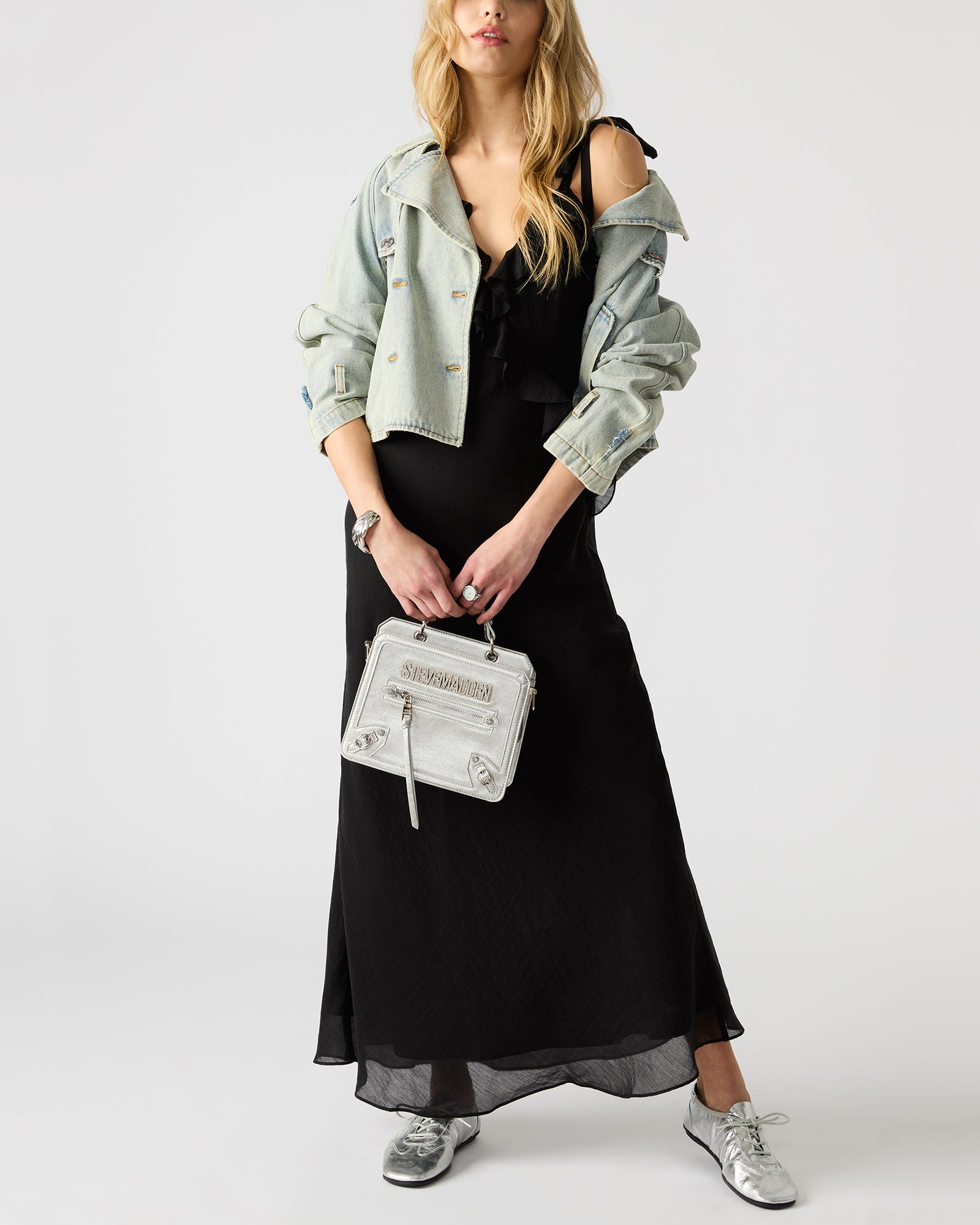 Side angle of structured top-handle bag with adjustable crossbody strap
