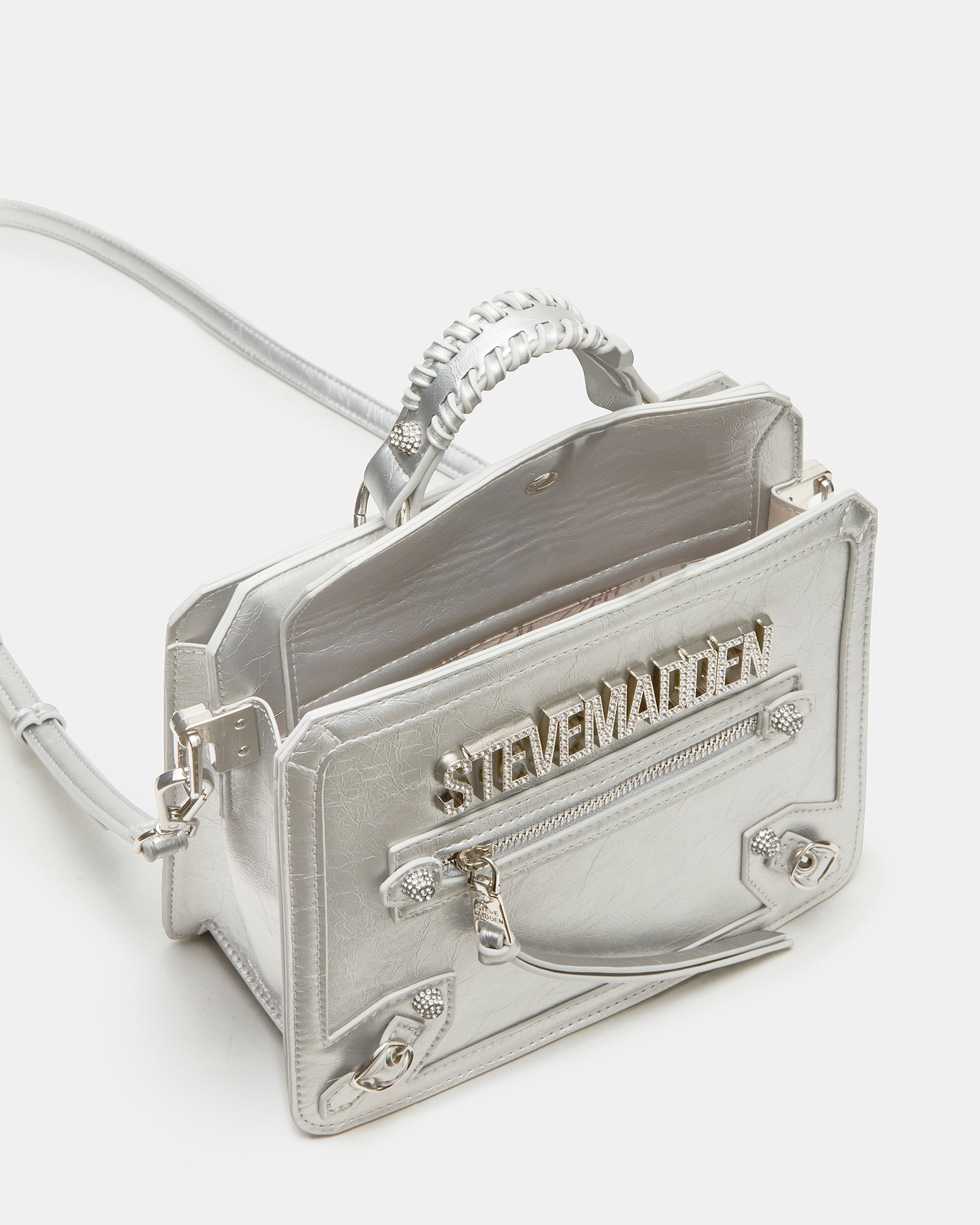 Side angle of structured top-handle bag with adjustable crossbody strap