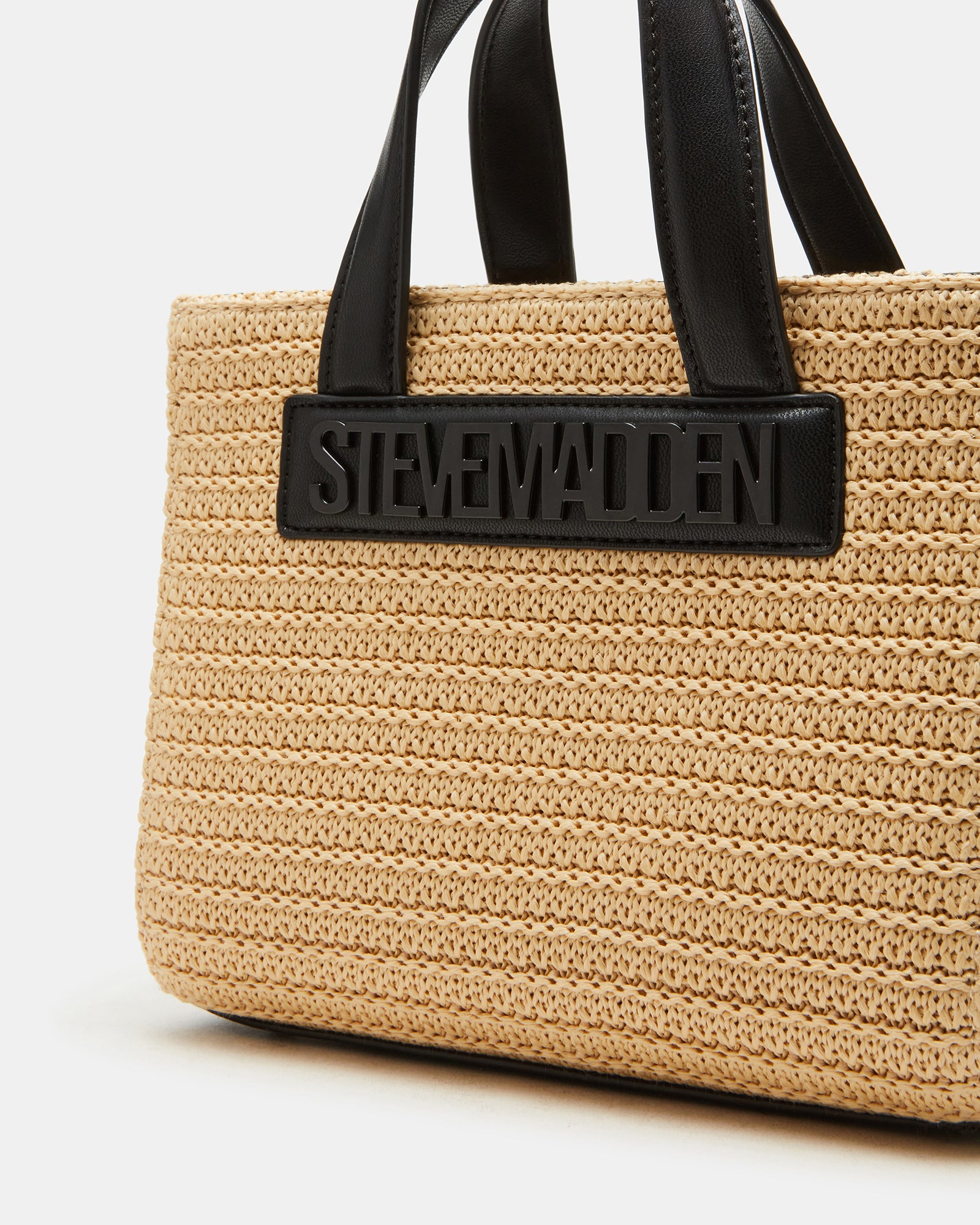 Styled image of the straw tote bag worn crossbody for hands-free convenience