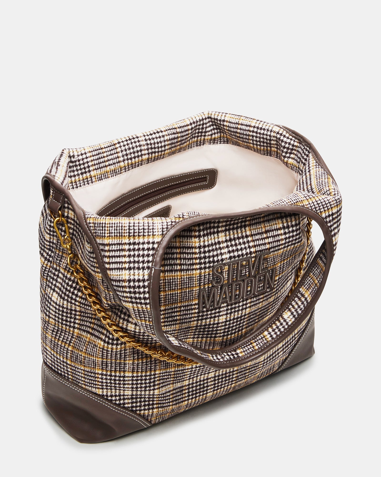 Side angle of the plaid handbag featuring the detachable curb chain and charm.