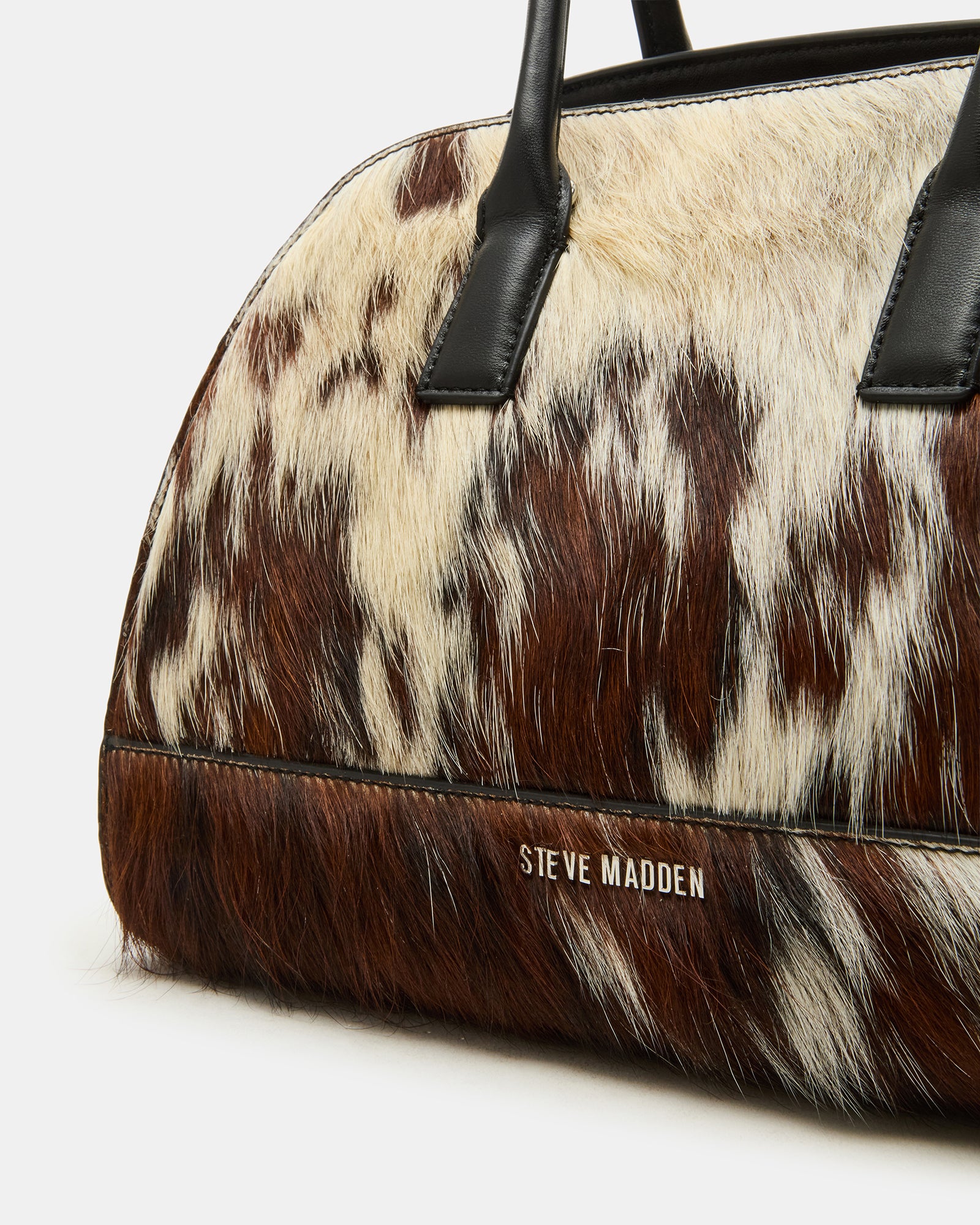 Hadlee cow print tote bag with tubular top handles and gold hardware