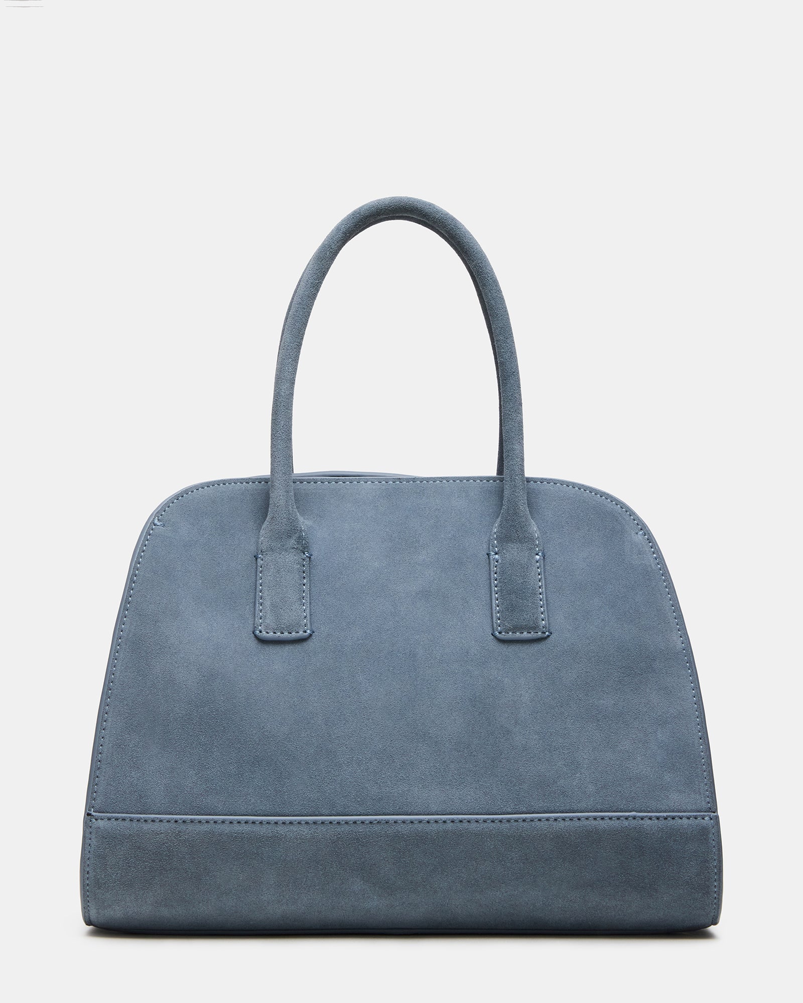 Luxury suede tote packed with essentials on boutique counter