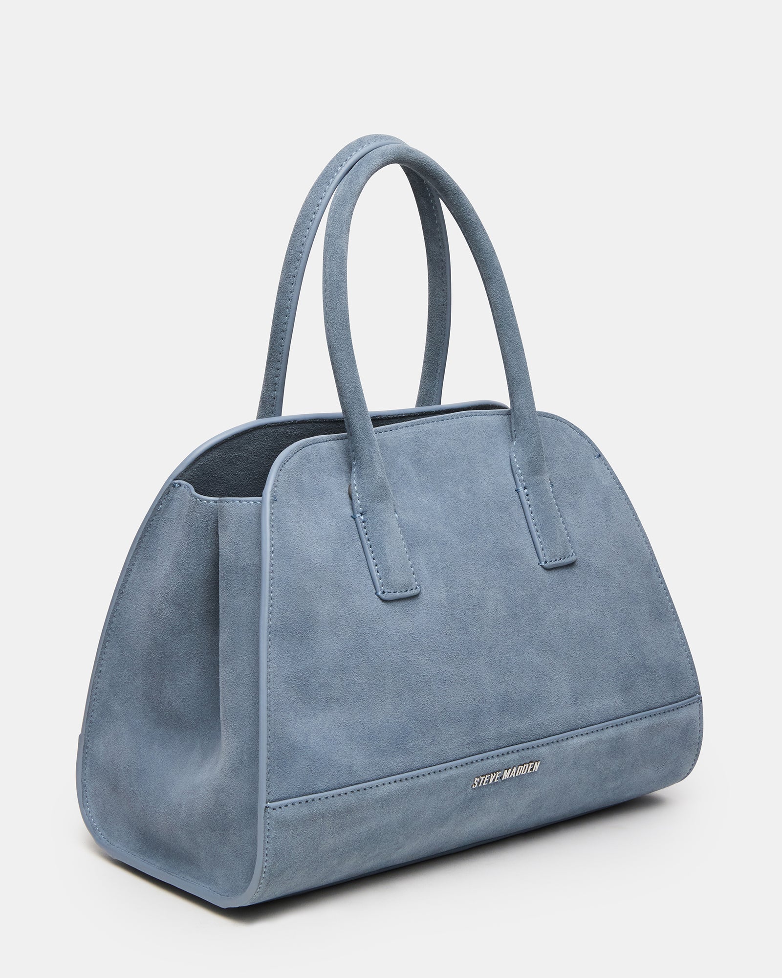 Hadlee baby blue suede handbag worn crossbody with coffee cup