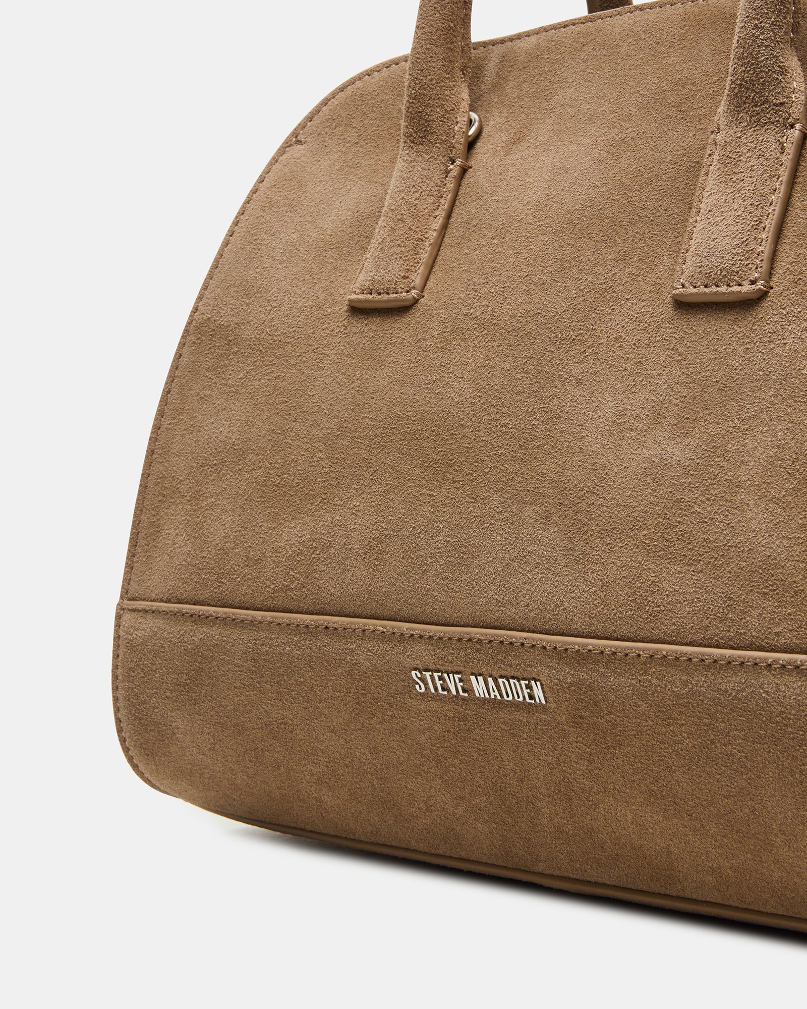 Lifestyle image of the suede handbag worn as a crossbody bag