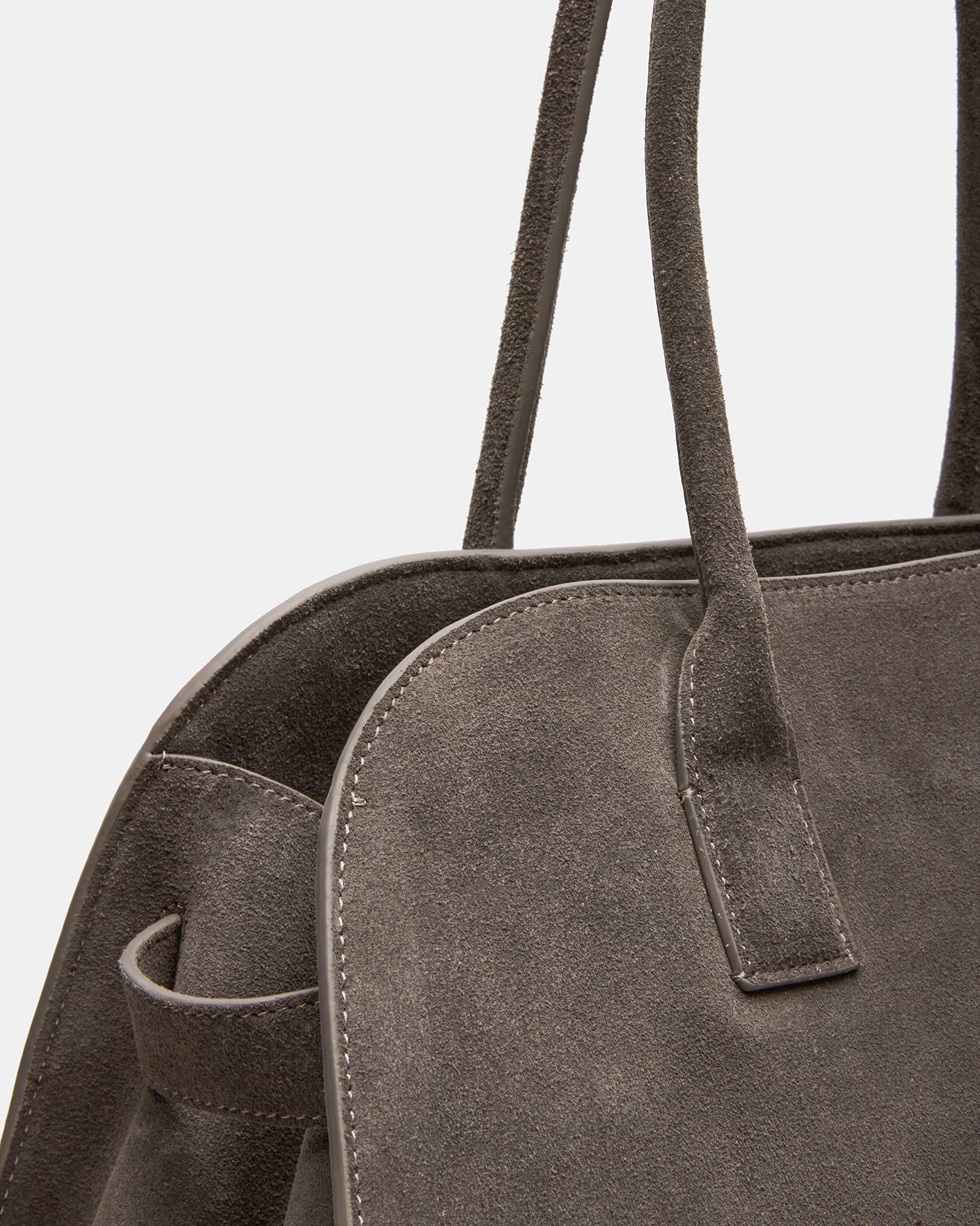 Model carrying the grey suede designer handbag for everyday use