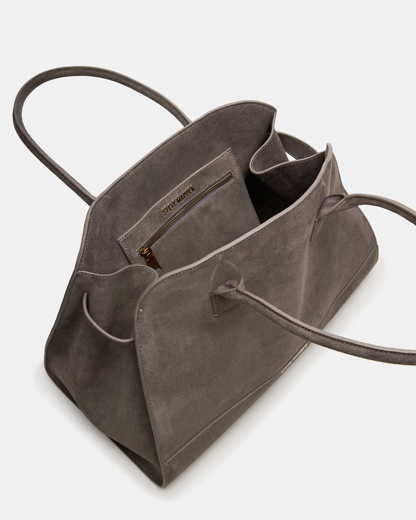 Model carrying the grey suede designer handbag for everyday use