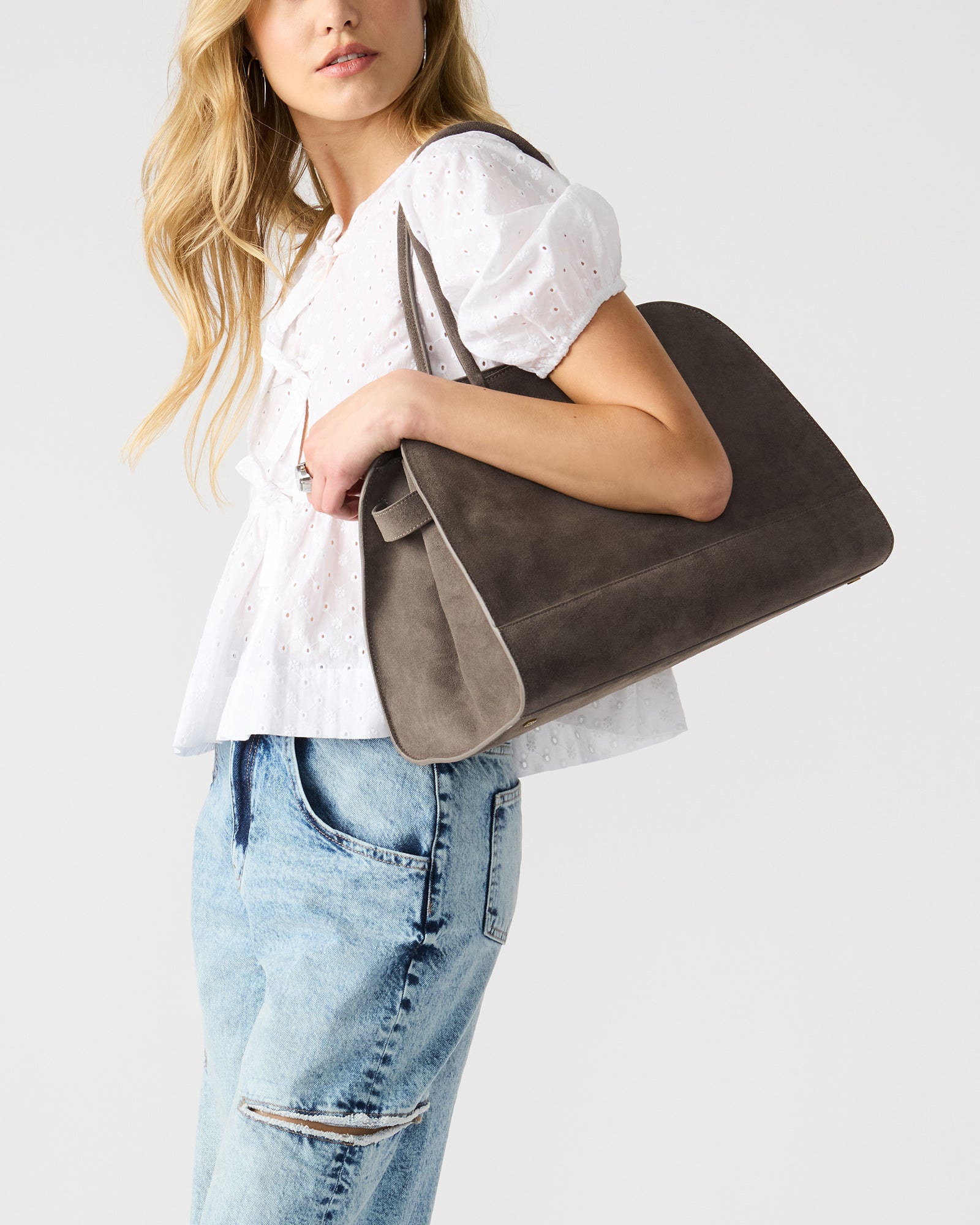 Interior view of the suede tote with inside zip pouch and spacious compartments