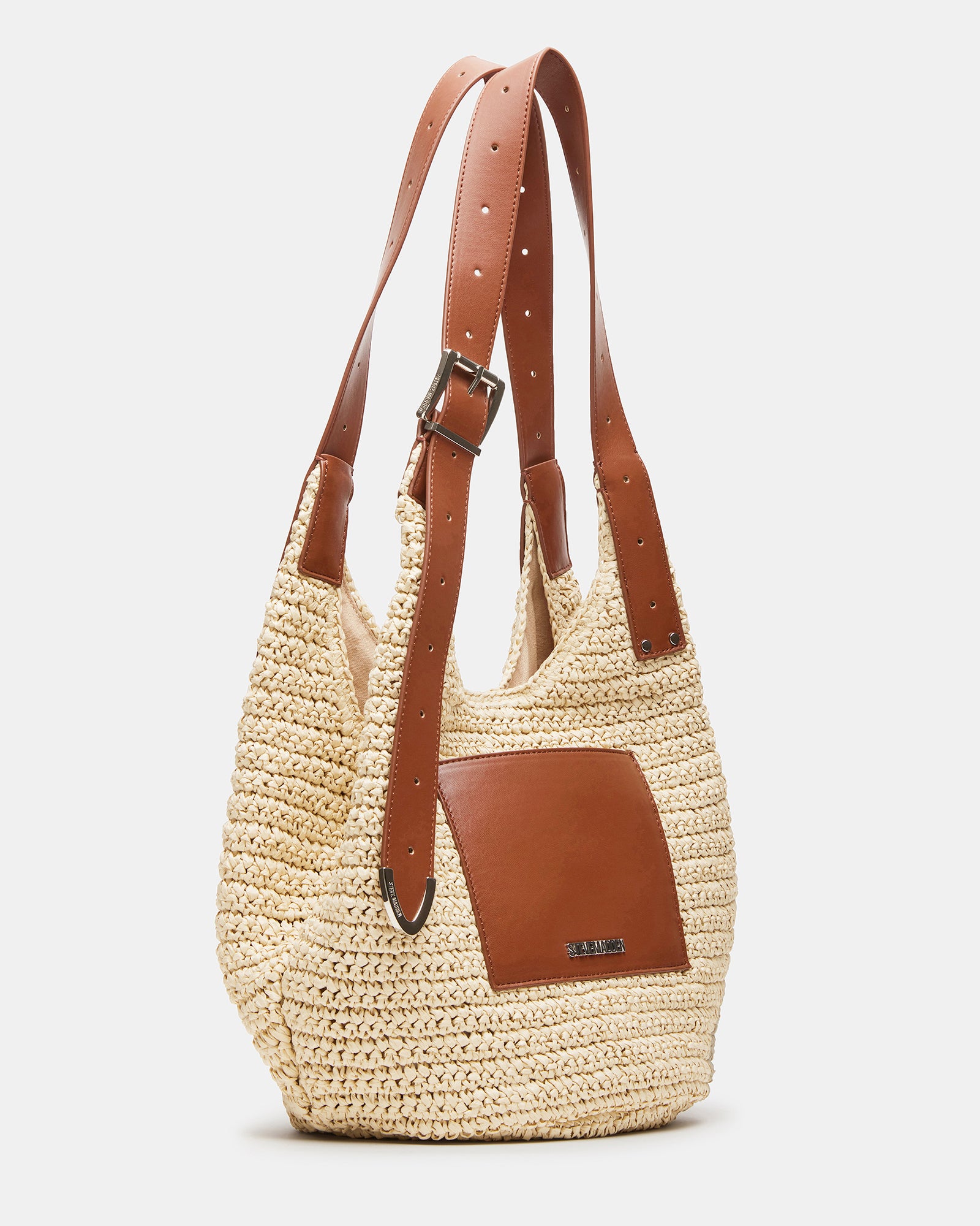 Fashionable straw hobo bag with buckle strap on a casual outfit