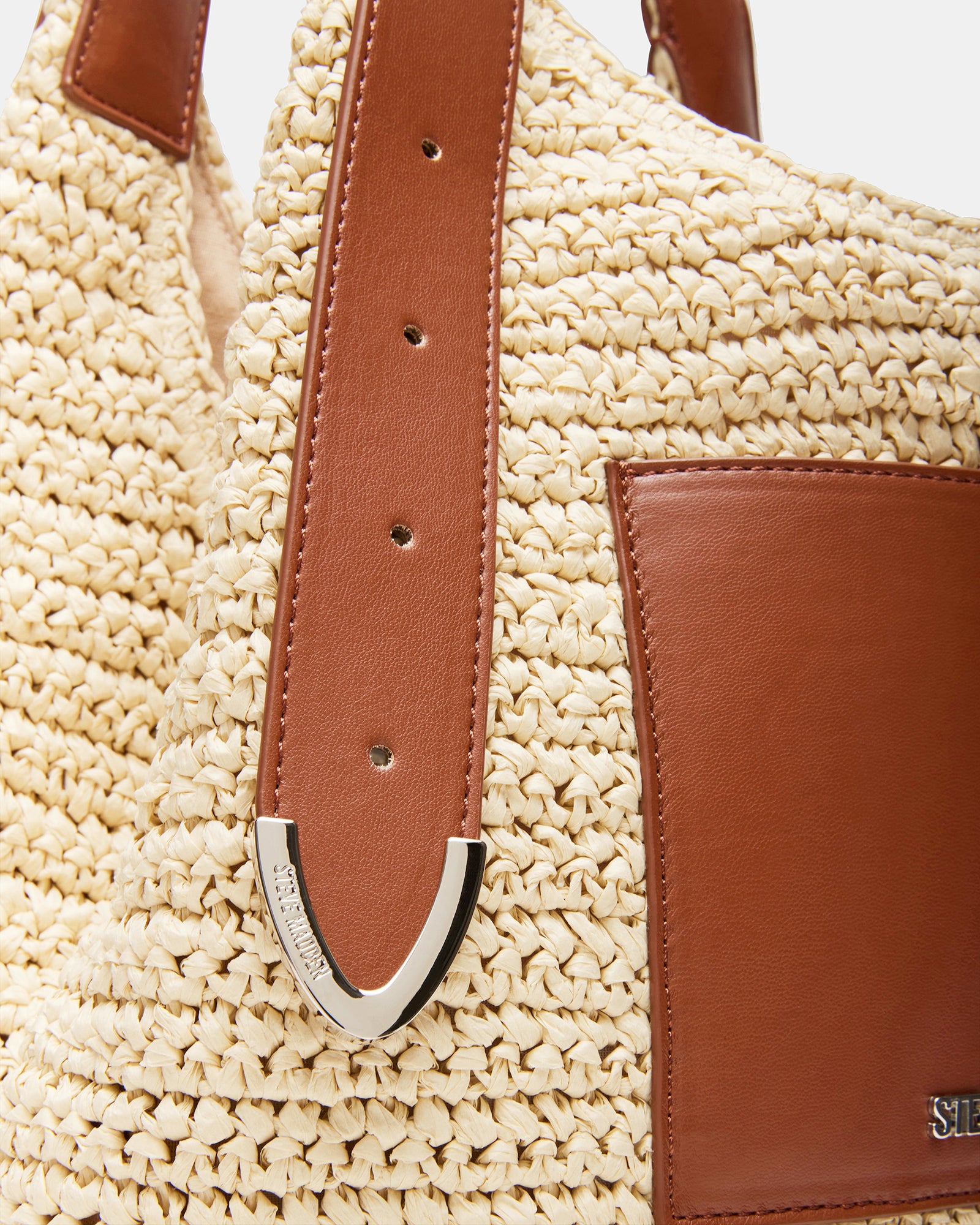Stylish straw bag with belt detail, perfect for summer trips