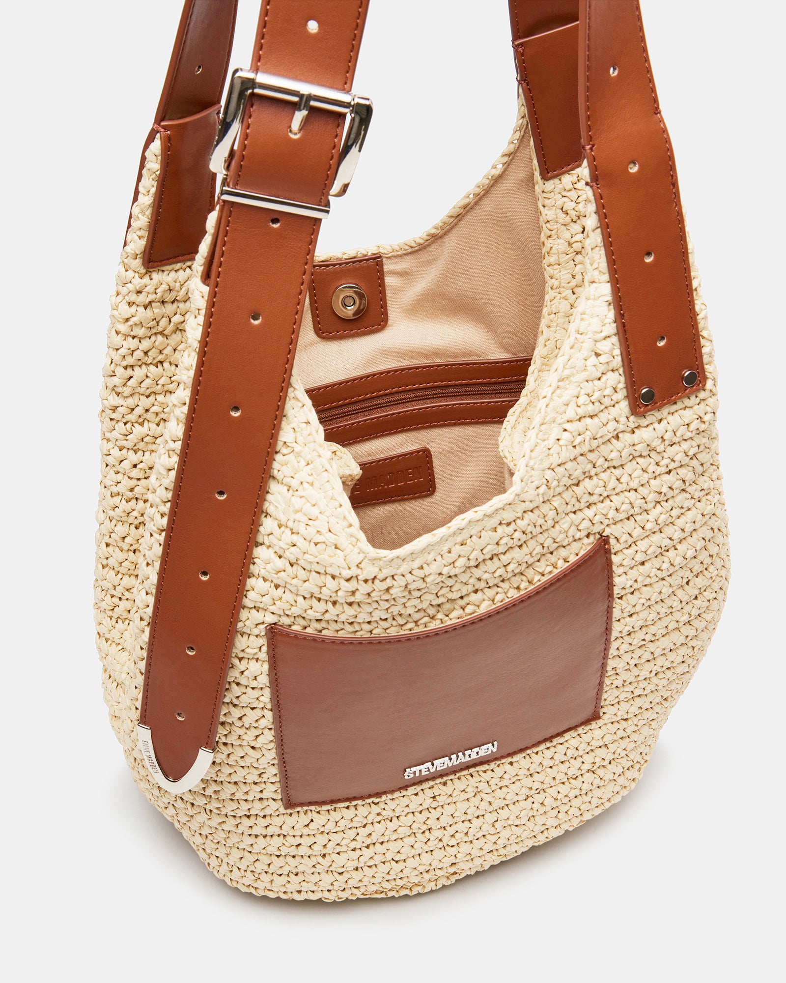 Close-up of the mag snap closure on the straw shoulder bag