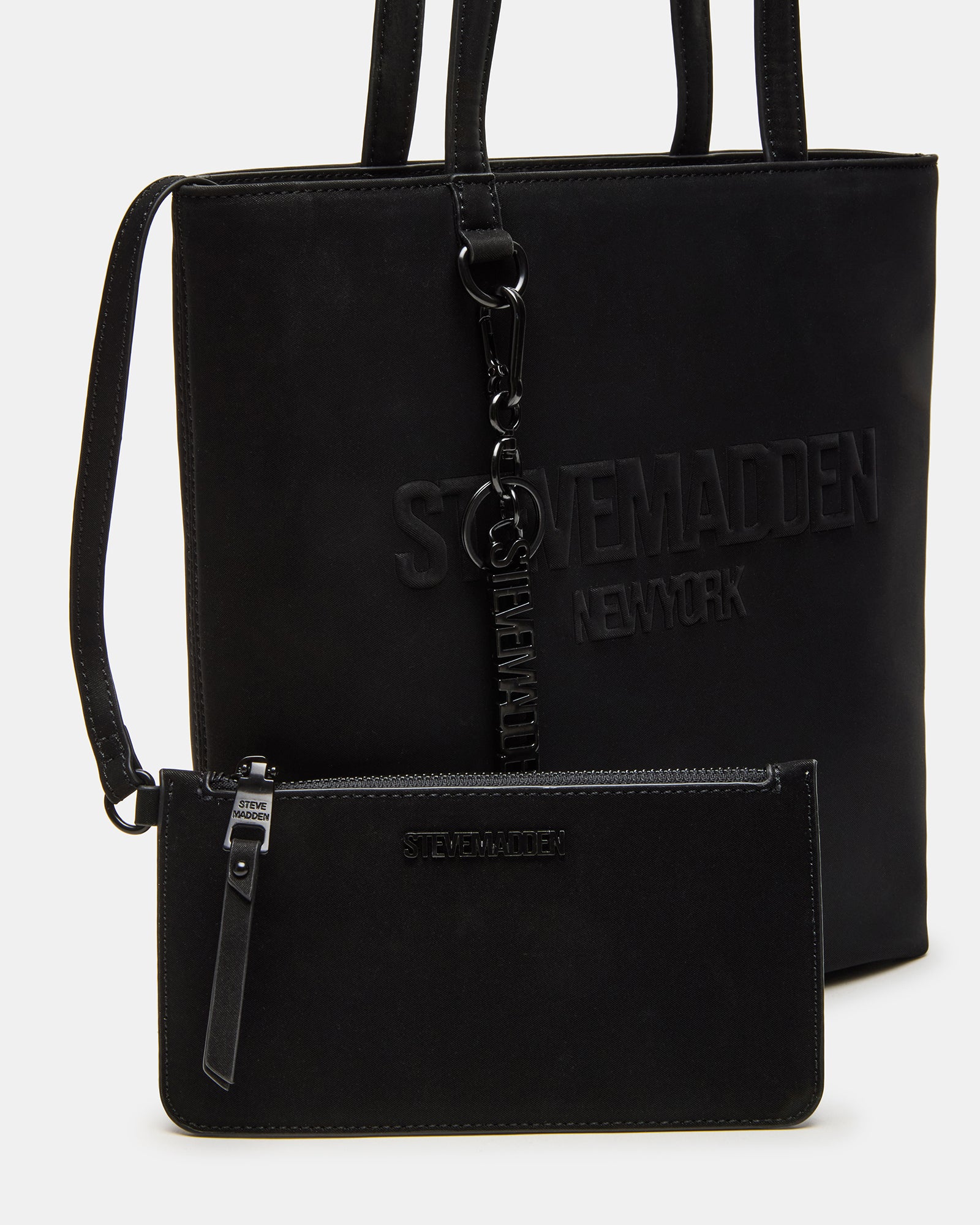Close-up of the top zipper closure and shoulder strap of the designer handbag