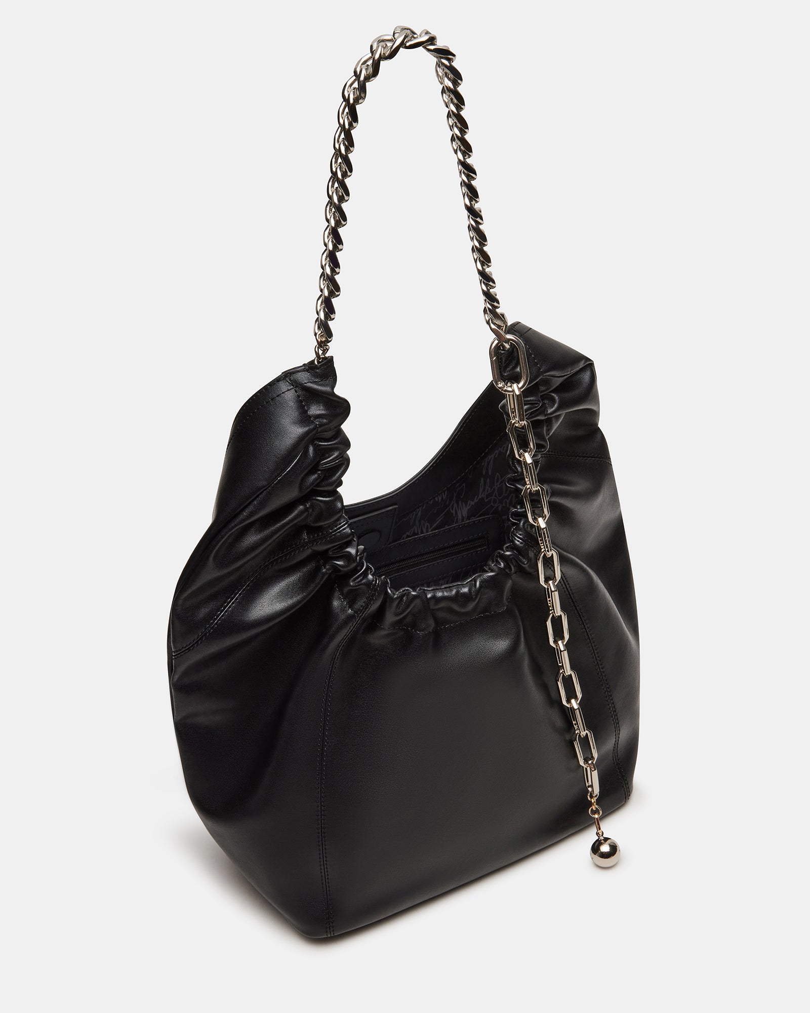 Model carrying the designer hobo bag crossbody in urban setting