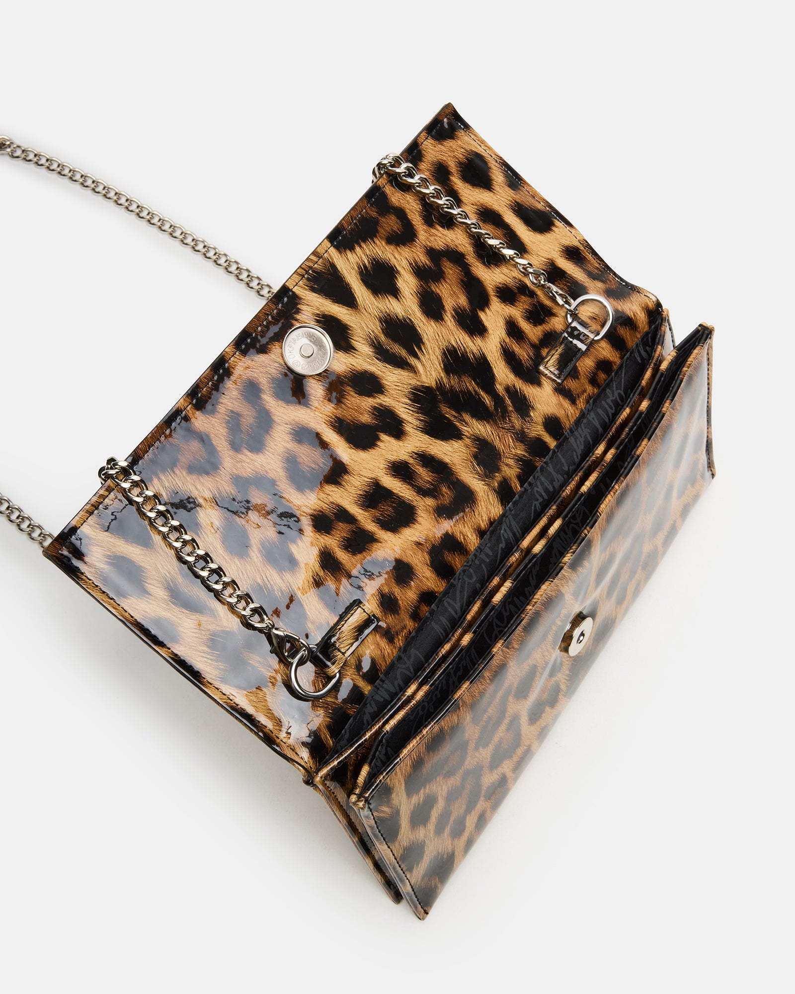 Leopard print designer clutch worn crossbody, demonstrating the 24-inch strap length.