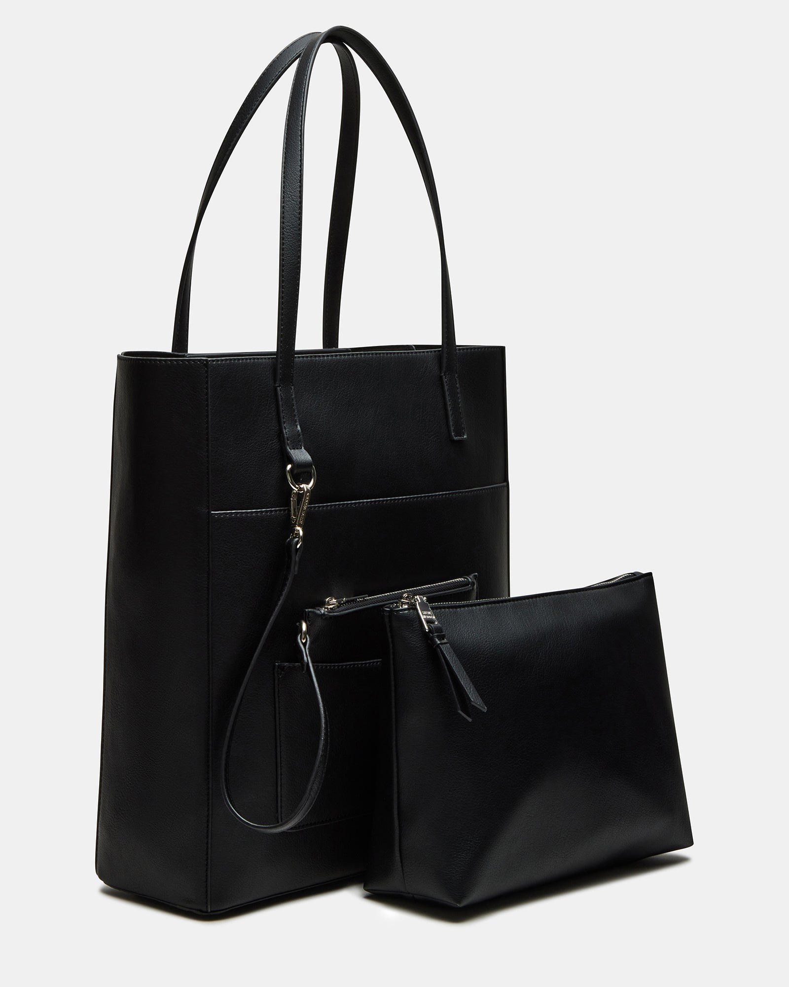 Front view of black handbag on model walking through Soho.