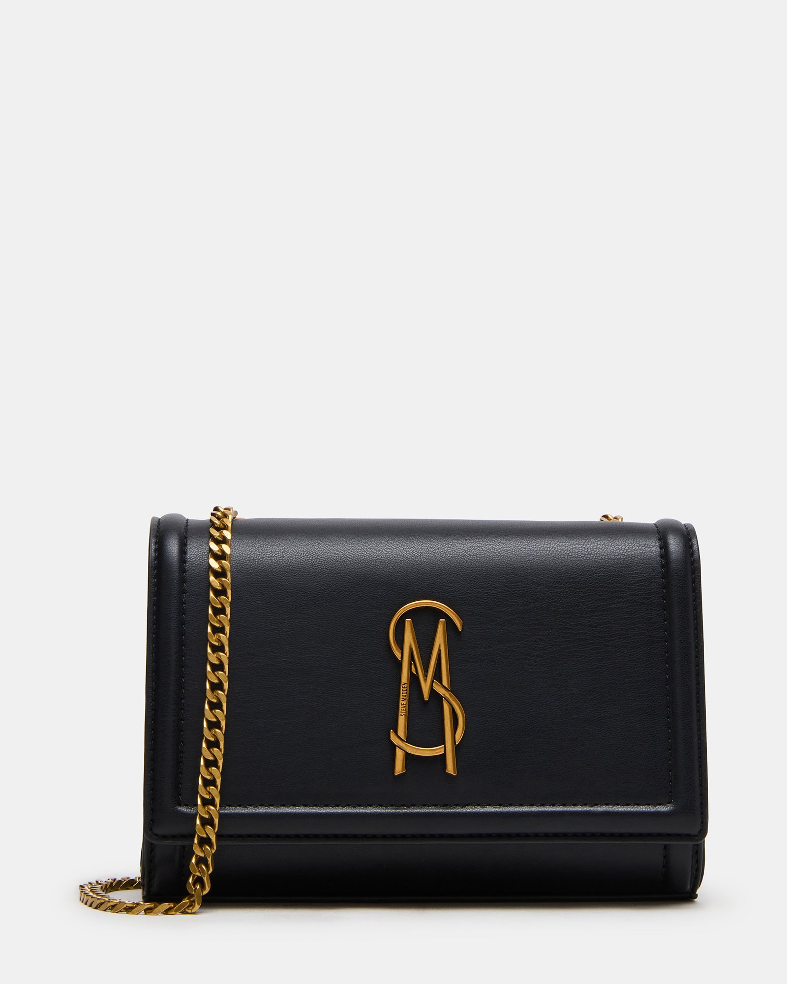 Black leather crossbody bag worn over the shoulder, showcasing magnetic closure.