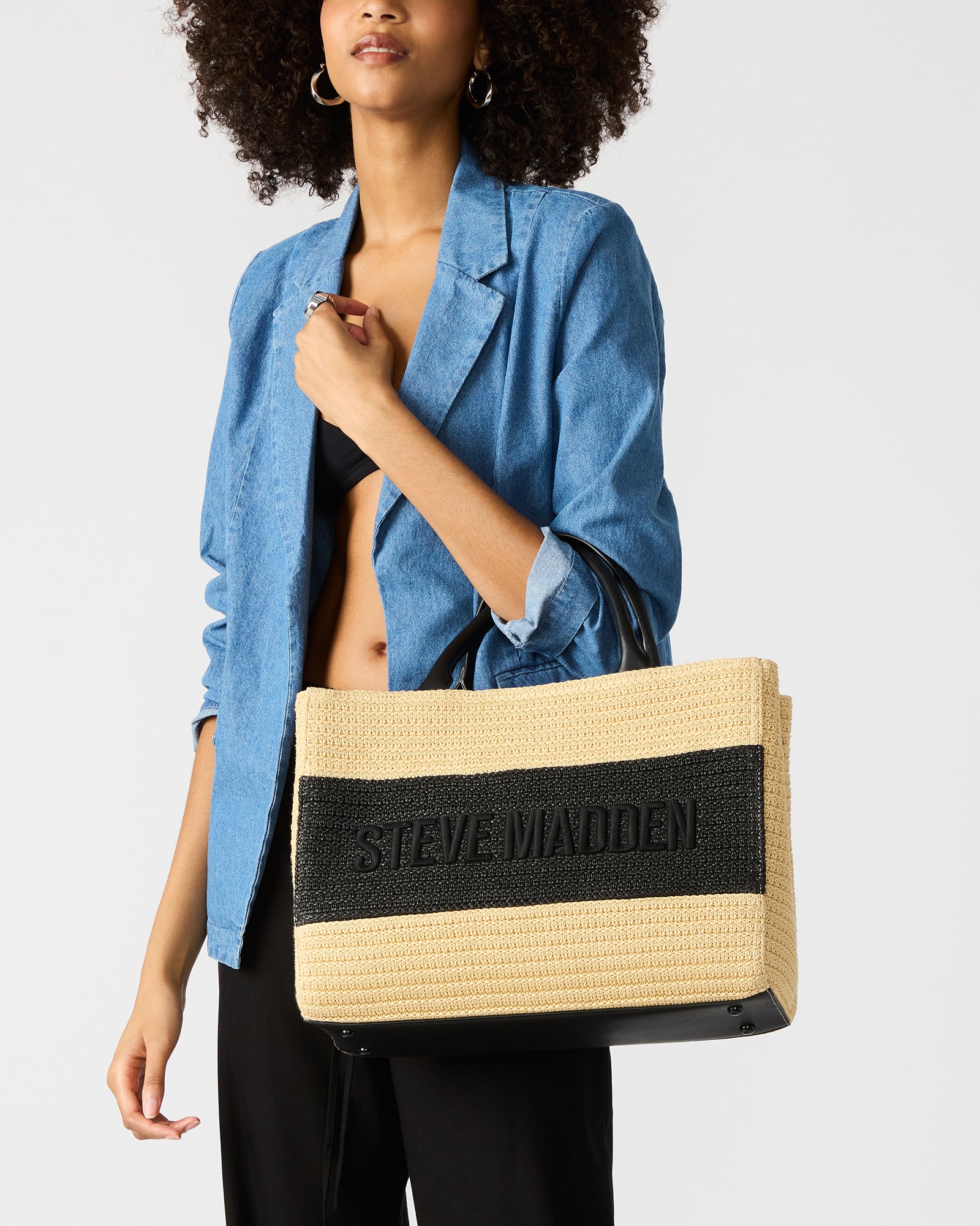 Side angle highlighting the adjustable crossbody strap and woven texture.